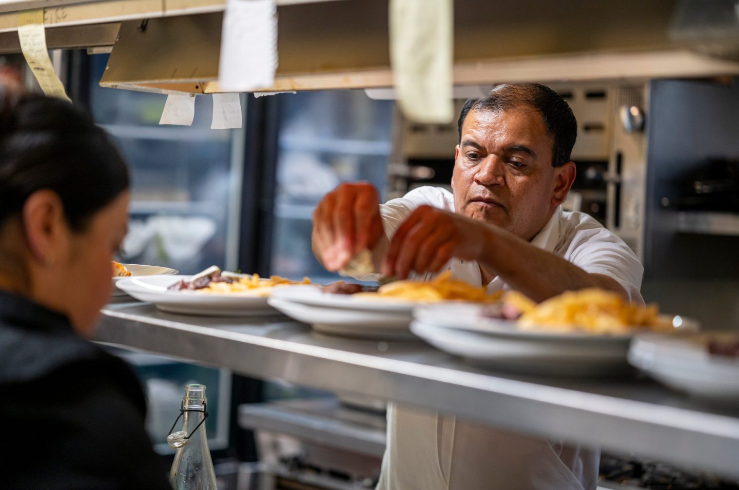 A chef prepares a dish in Le Central restaurant