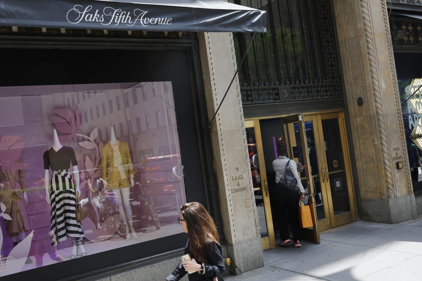 People enter a Saks Fifth Avenue store