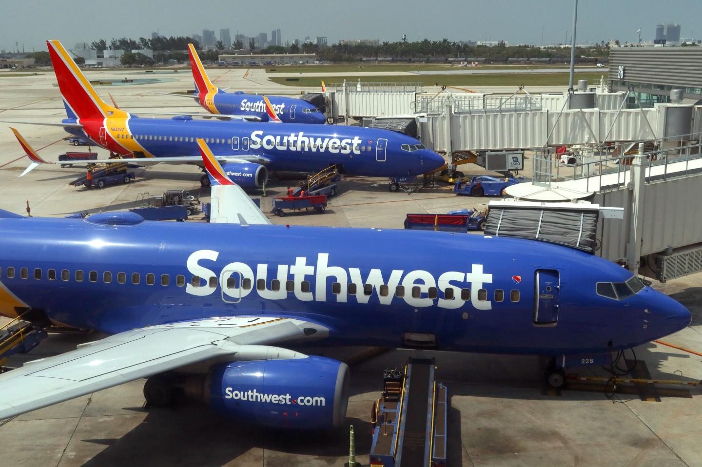 Three Southwest planes seen grounded at an airport.