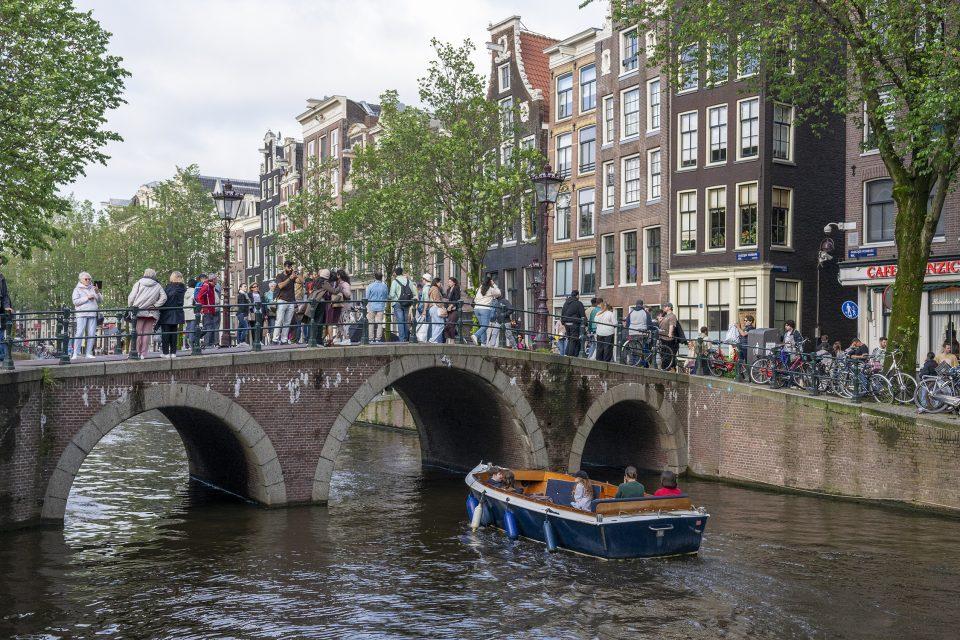 Tourists visiting the city take boat trips on the canals in Amsterdam