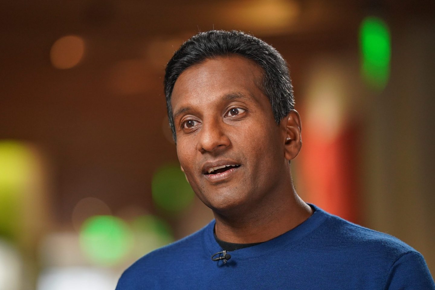 middle-aged man wearing blue t-shirt speaking during an interview