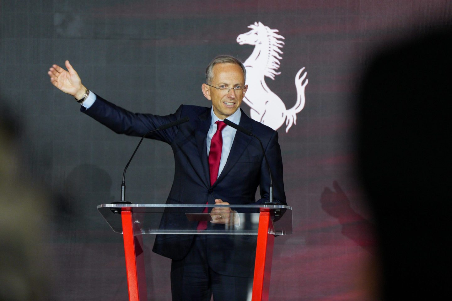 Ferrari CEO Benedetto Vigna speaks at podium