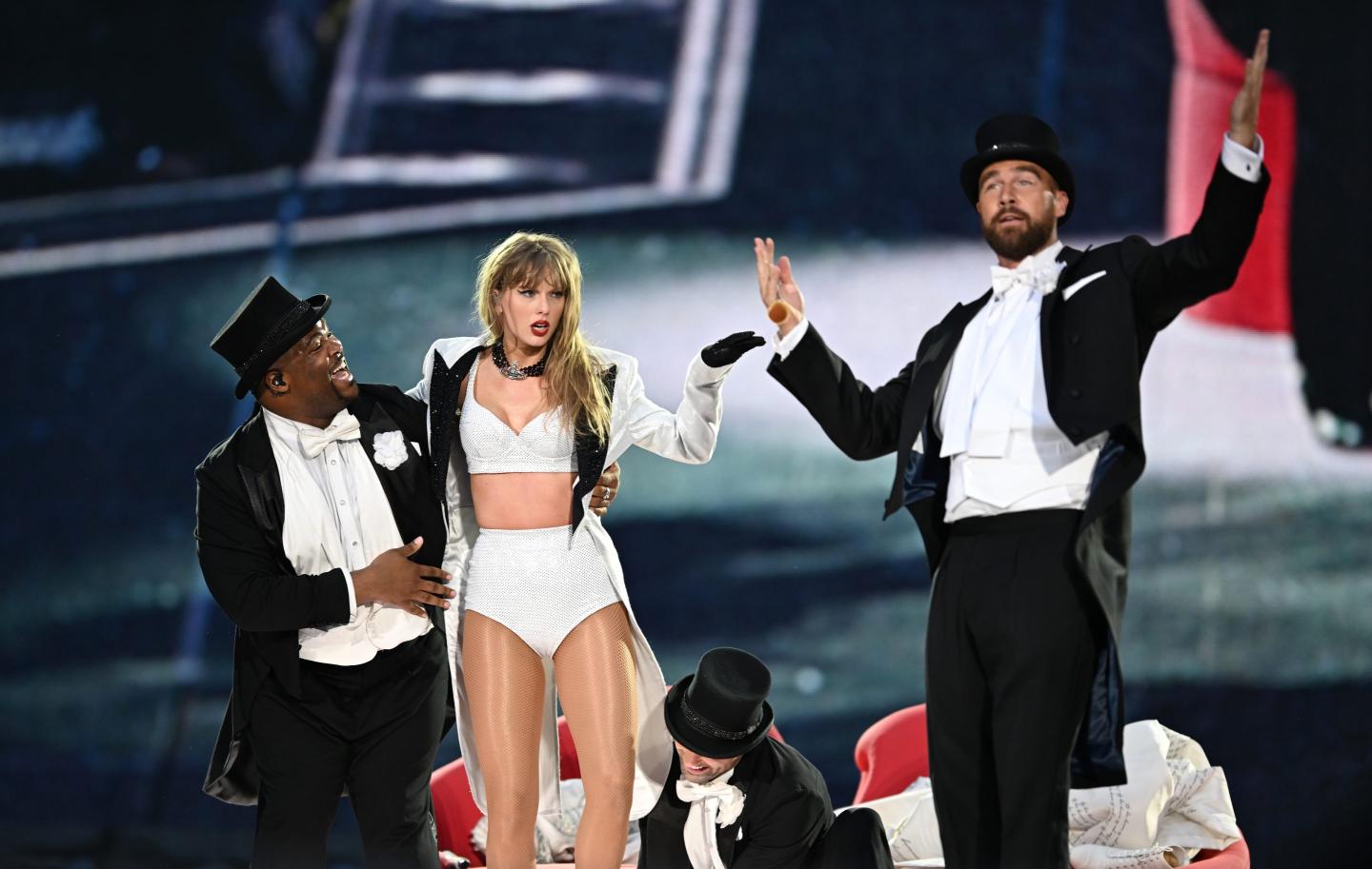 Taylor Swift is joined on stage by Travis Kelce (R), during "Taylor Swift | The Eras Tour" at Wembley Stadium on June 23, 2024 in London, England.