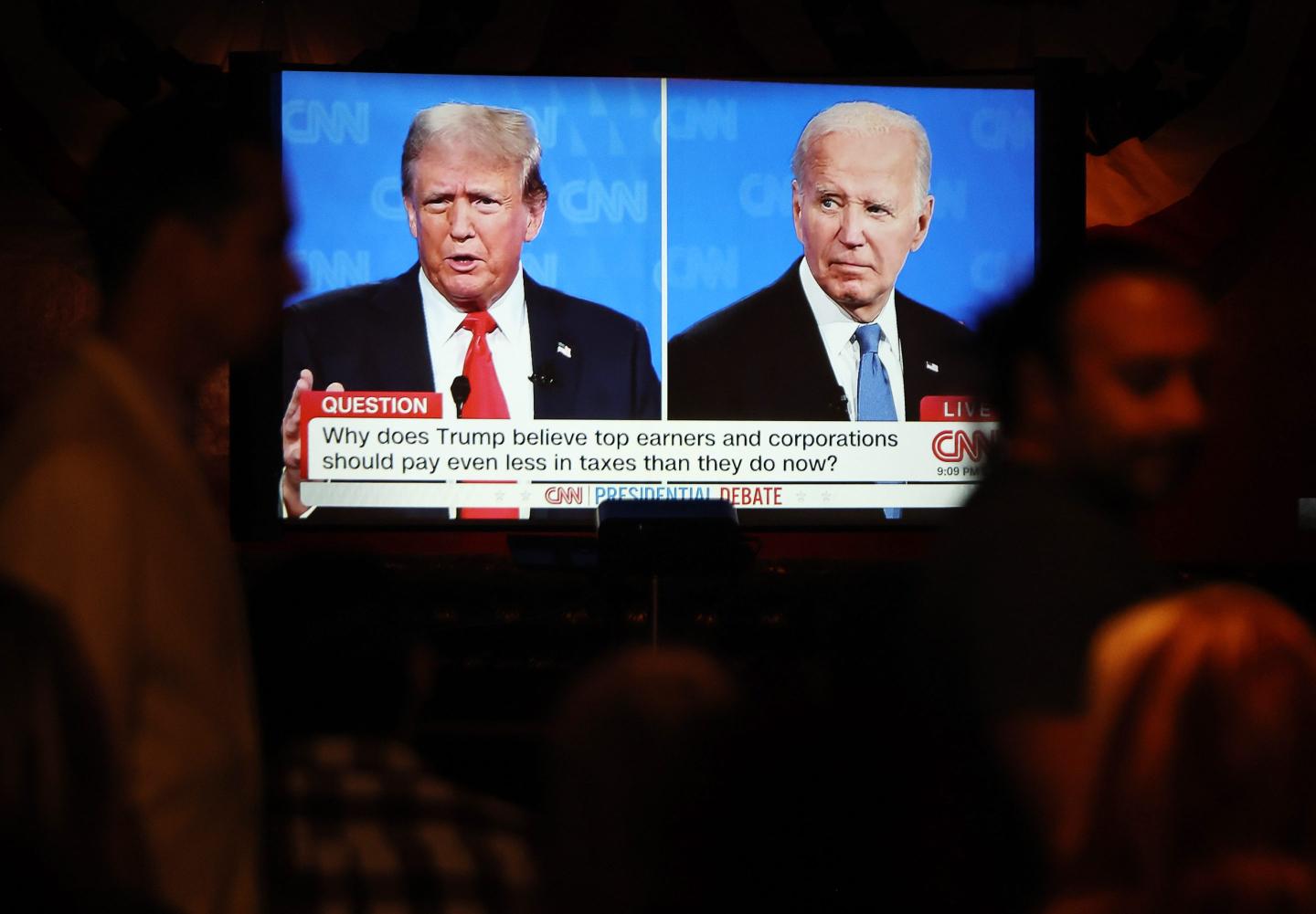 People watch the CNN presidential debate between U.S. President Joe Biden and Republican presidential candidate former President Donald Trump
