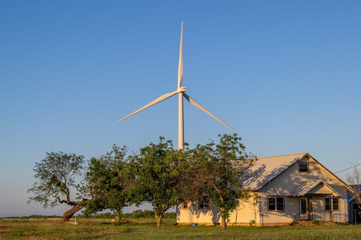 A wind turbine behind a house