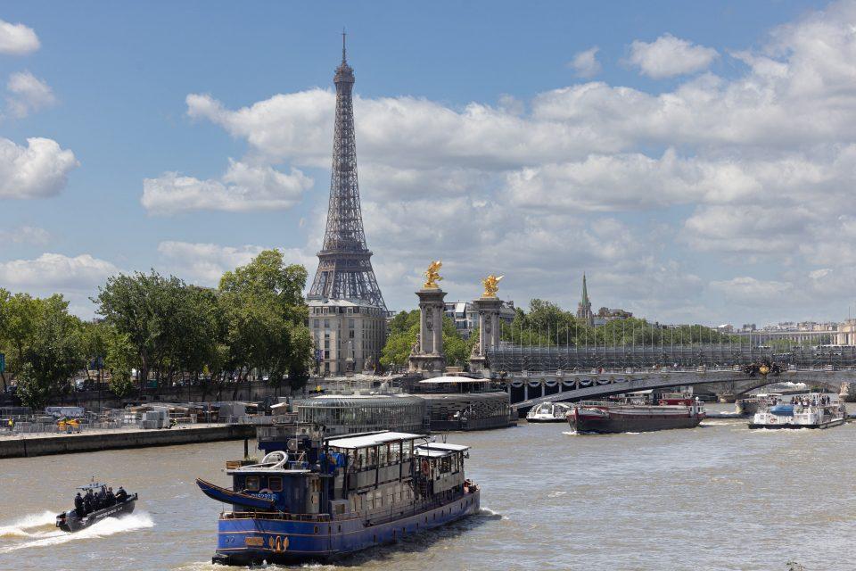 Seine River with cruises on it, Eiffel Tower in the background.