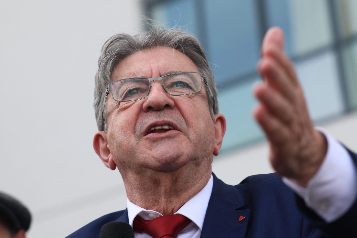 Jean-Luc Melenchon holds out hand
