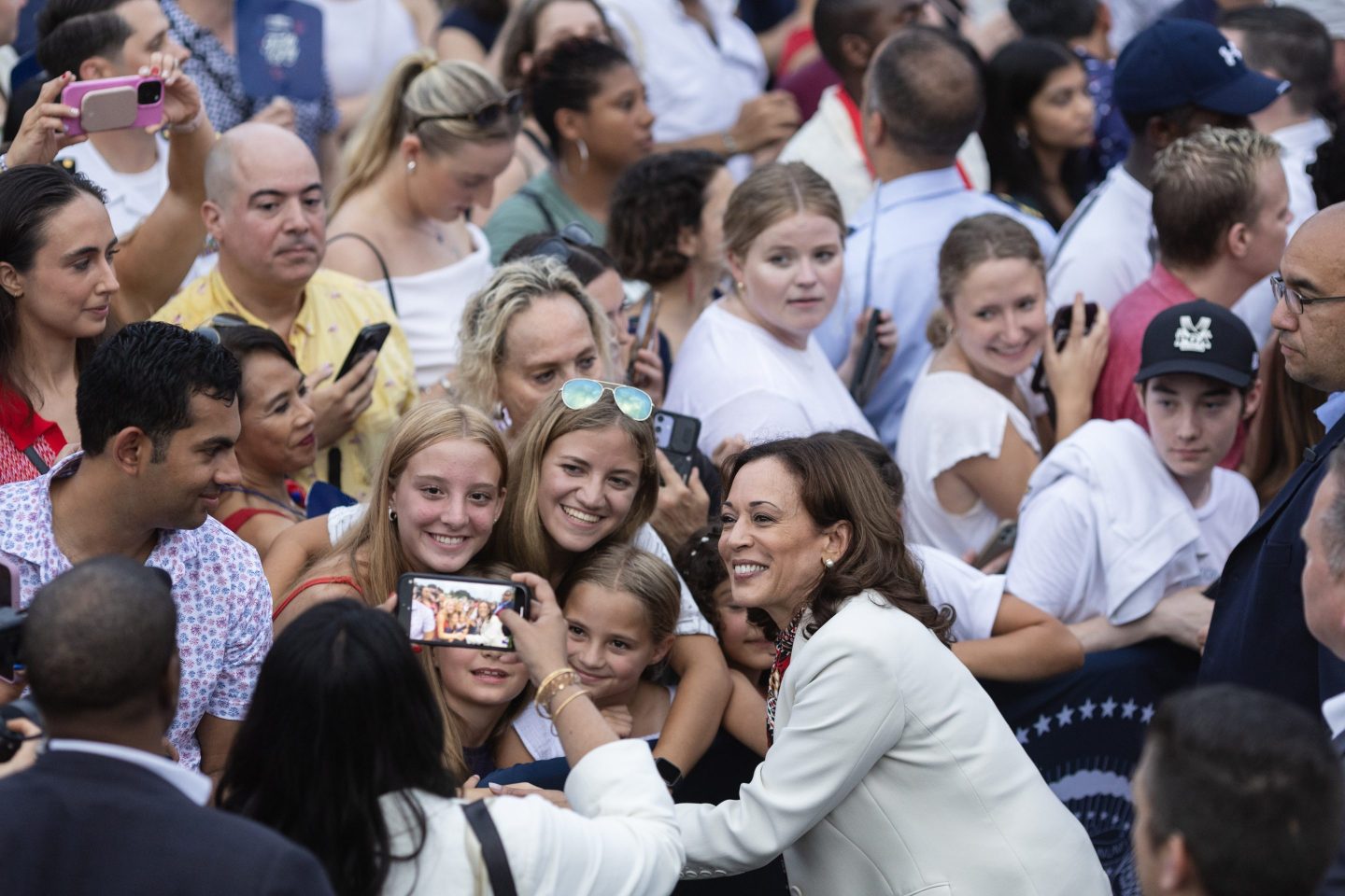 Vice President and presumptive nominee Kamala Harris takes selfies with young woman during an Independence Day celebration at the White House.