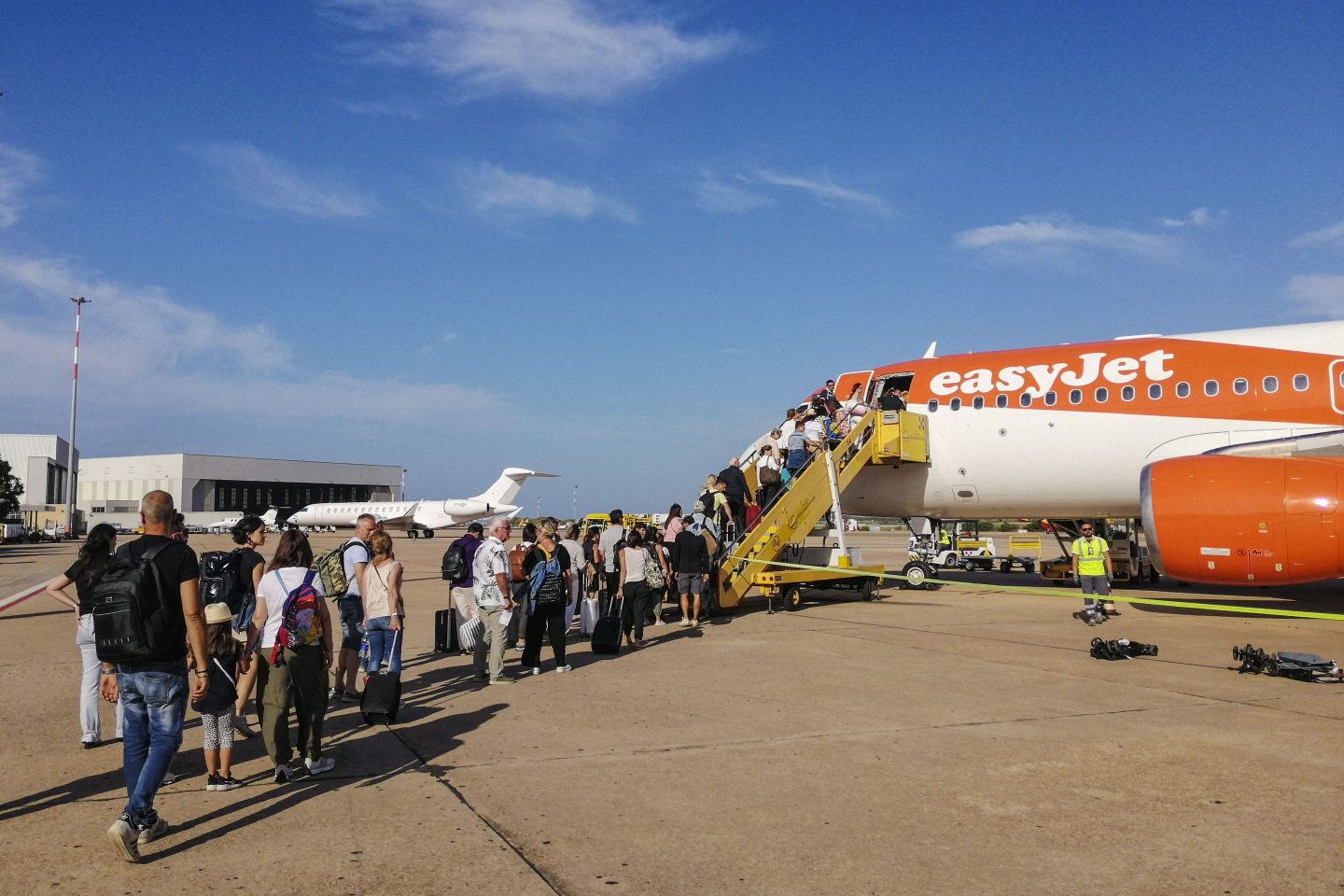 people queuing up to board an easyjet flight