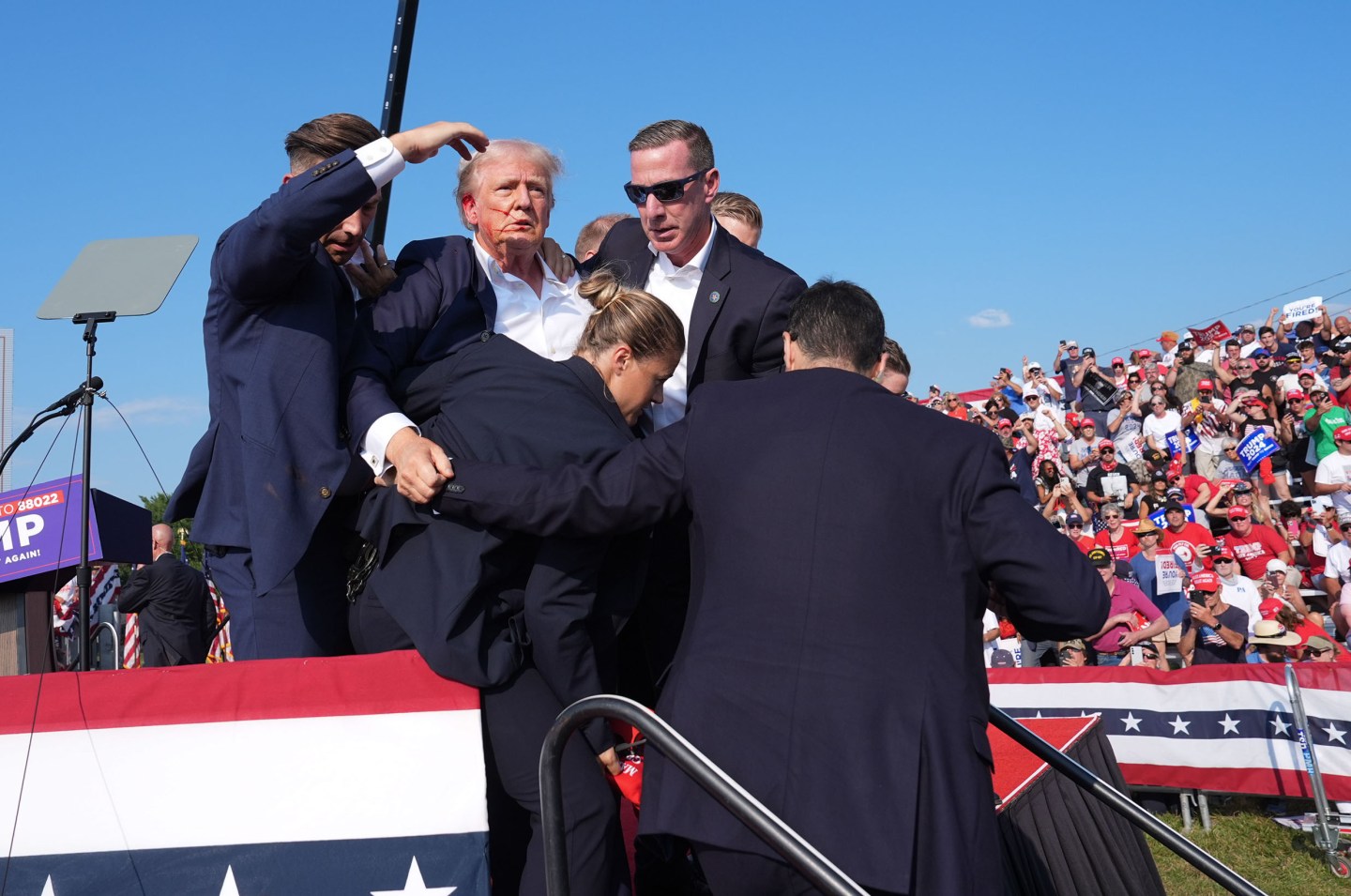 Former president Donald Trump is assisted offstage during a campaign rally for former President Donald Trump at Butler Farm Show Inc. on Saturday, July 13, 2024 in Butler, Pa.