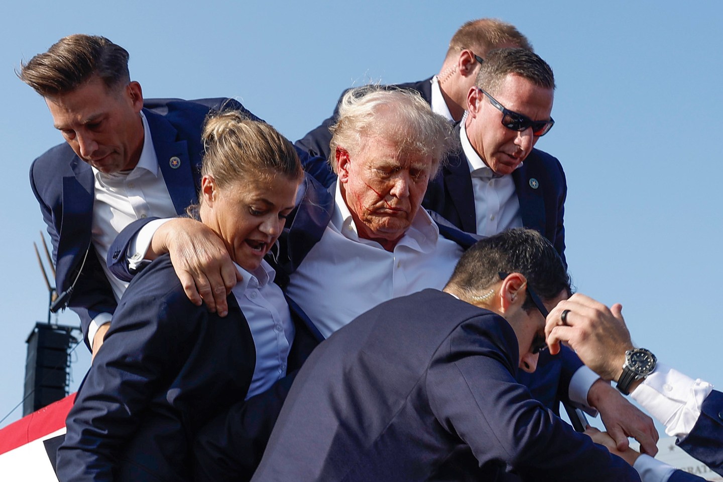 Republican presidential candidate former President Donald Trump is rushed offstage by U.S. Secret Service agents after being grazed by a bullet