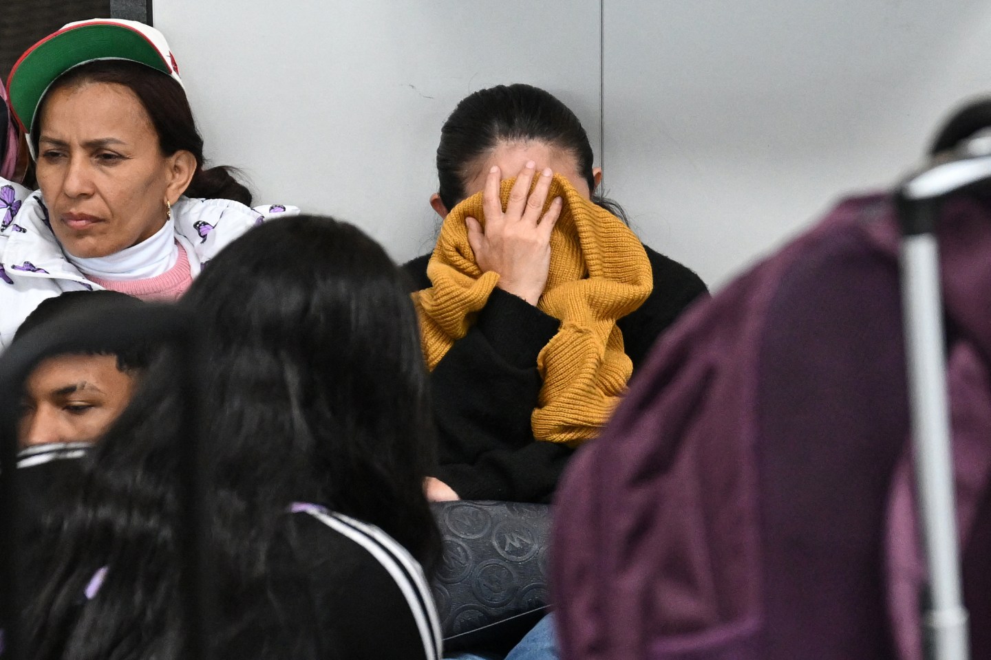 A woman covers her face