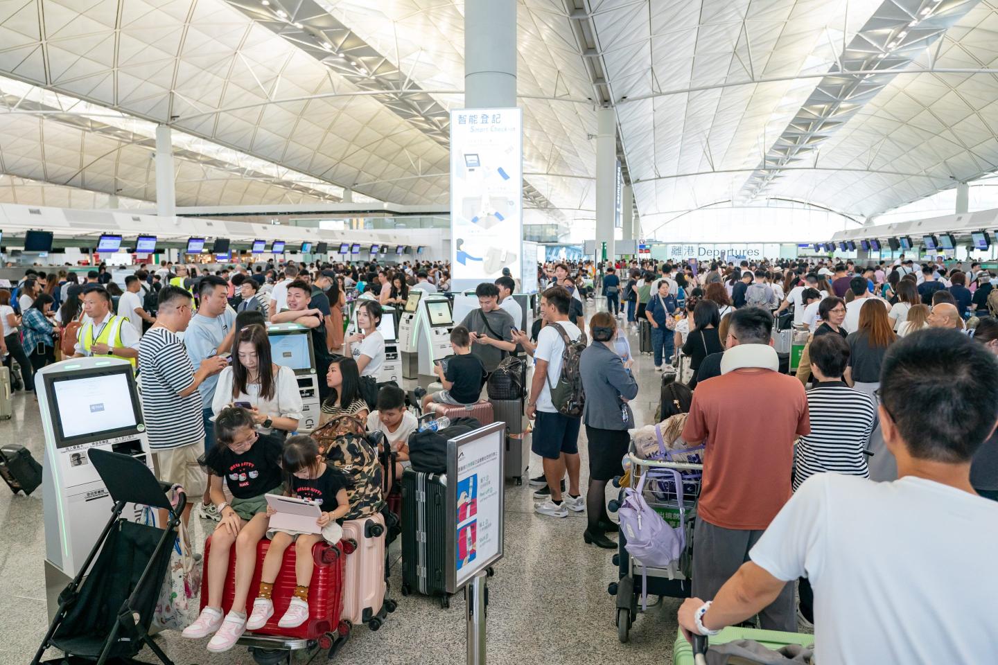 Travellers queue up at the check-in counters of the Hong Kong International Airport on July 19, 2024 as a significant Microsoft outage impacted users globally.