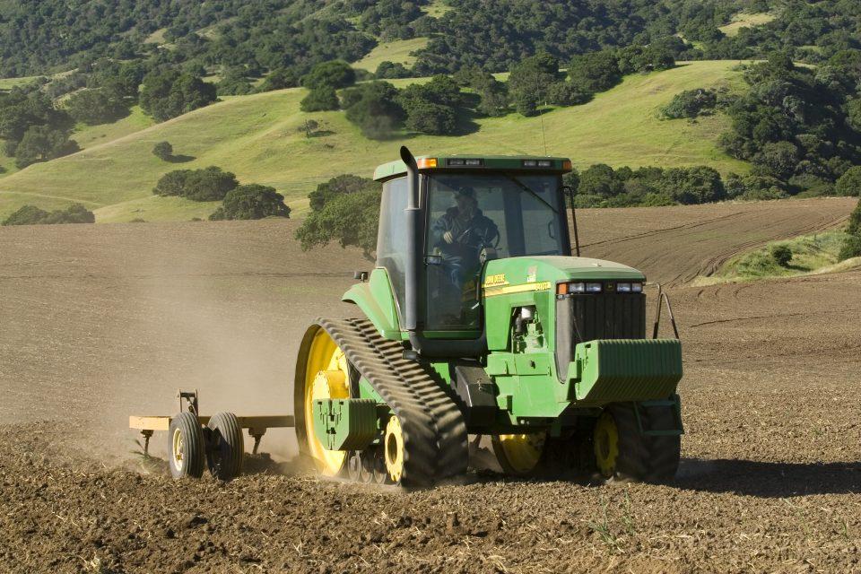 Agriculture - A John Deere tracked tractor and field implement till a new field that will be planted in organic vegetable crops/near Salinas, Monterey County, California, USA. (Photo by: Ed Young/Design Pics Editorial/<a href="https://fortune.com/company/universal/" target="_blank">Universal</a> Images Group via Getty Images)