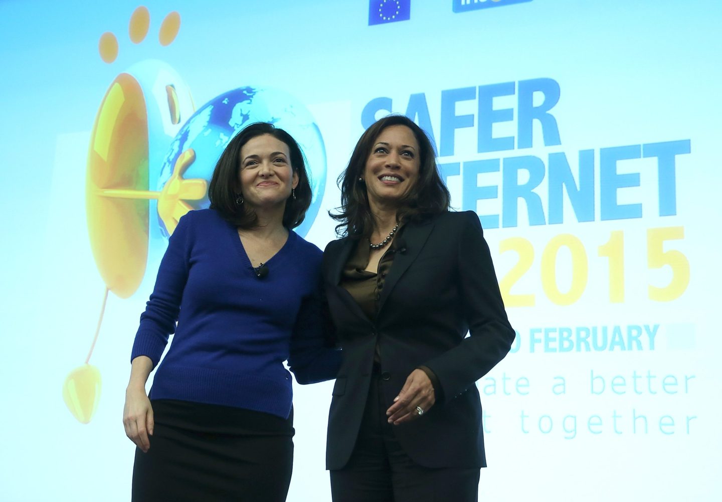 Then-California Attorney General Kamala Harris (R) and Facebook COO Sheryl Sandberg stand on stage during a Safer Internet Day event at Facebook headquarters on February 10, 2015 in Menlo Park, California.