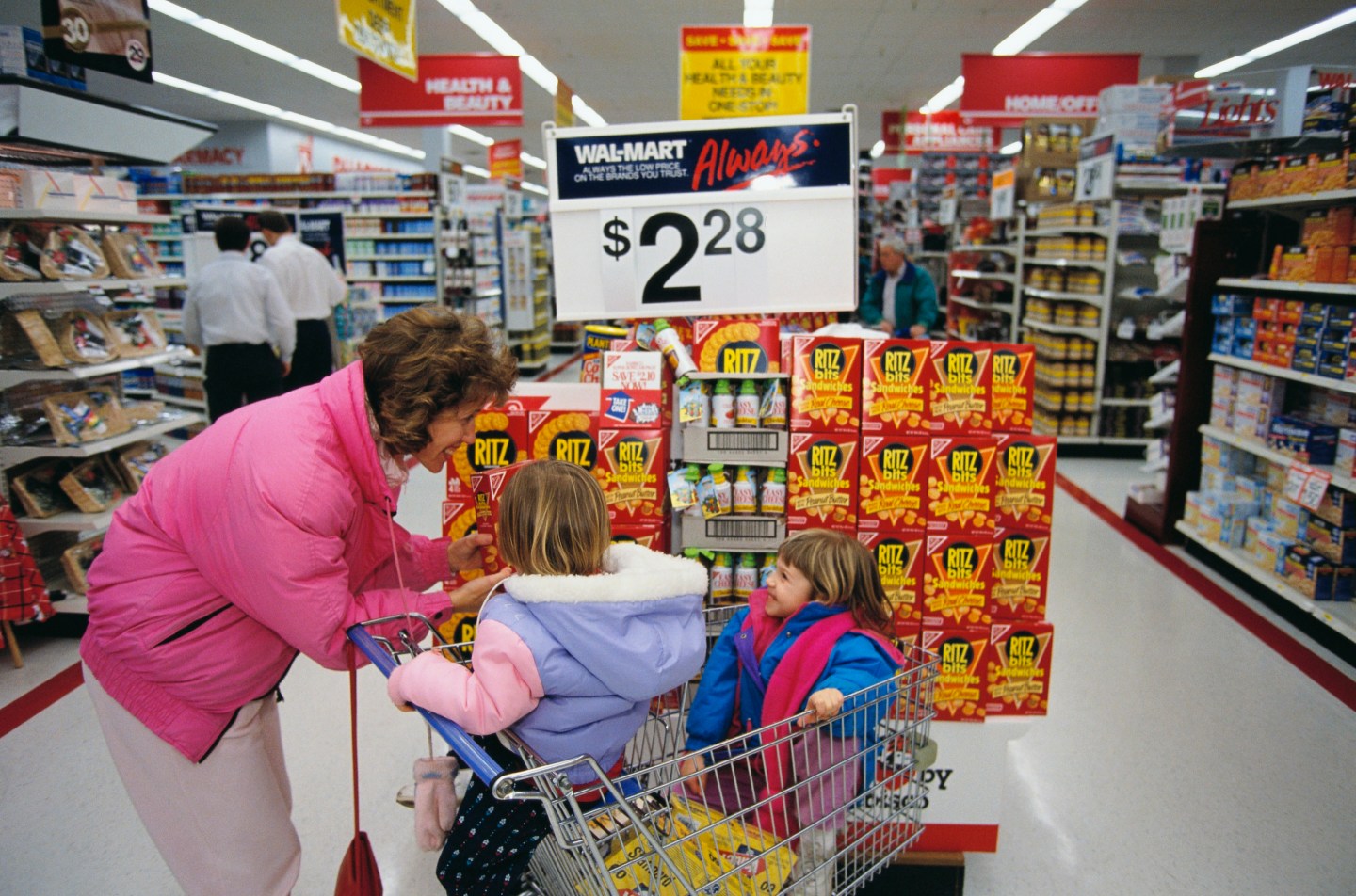 A woman and two children shop at a Wal-Mart store in the early 1990s.
