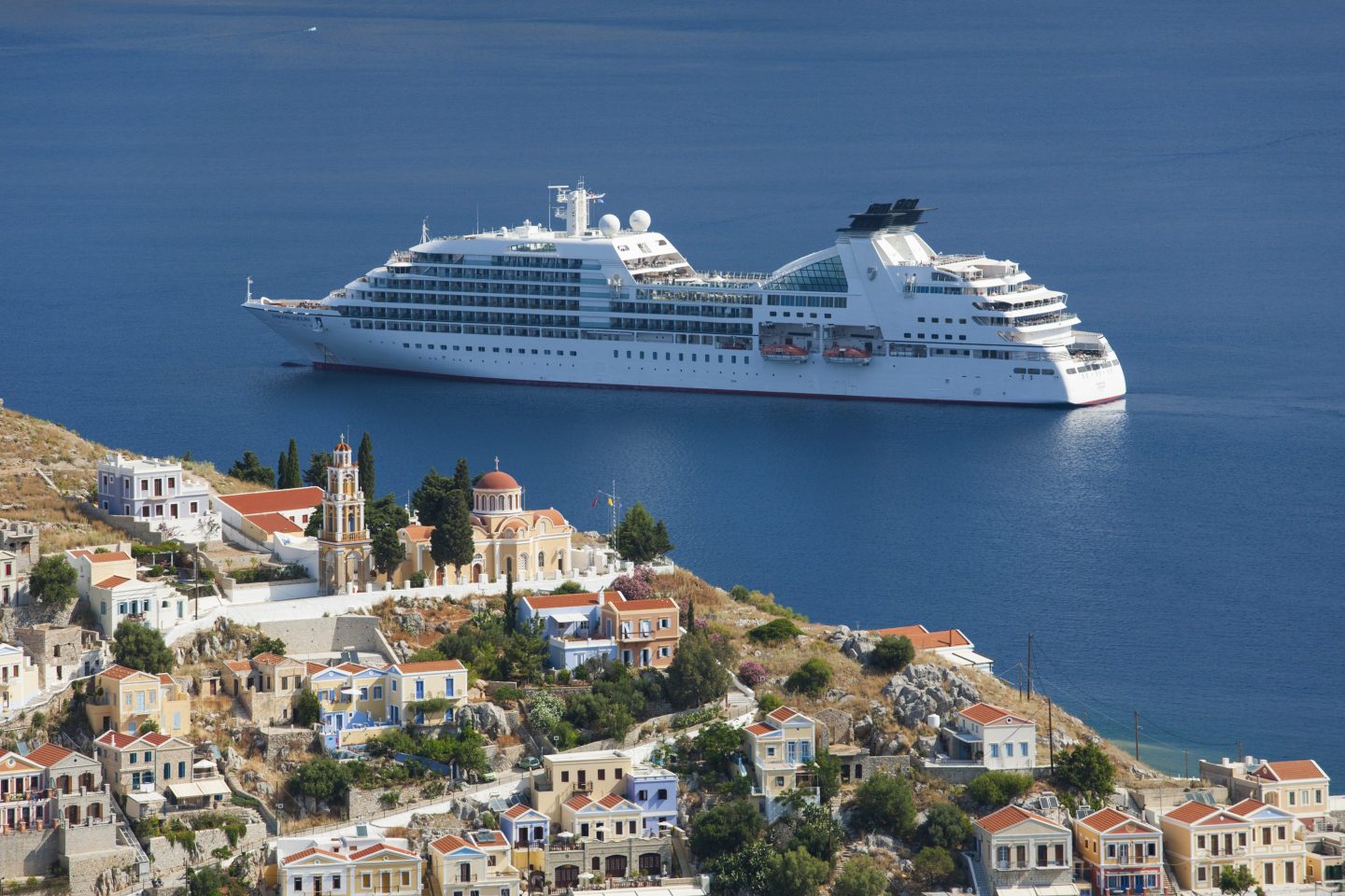 A cruise ship anchored offshore in Greece