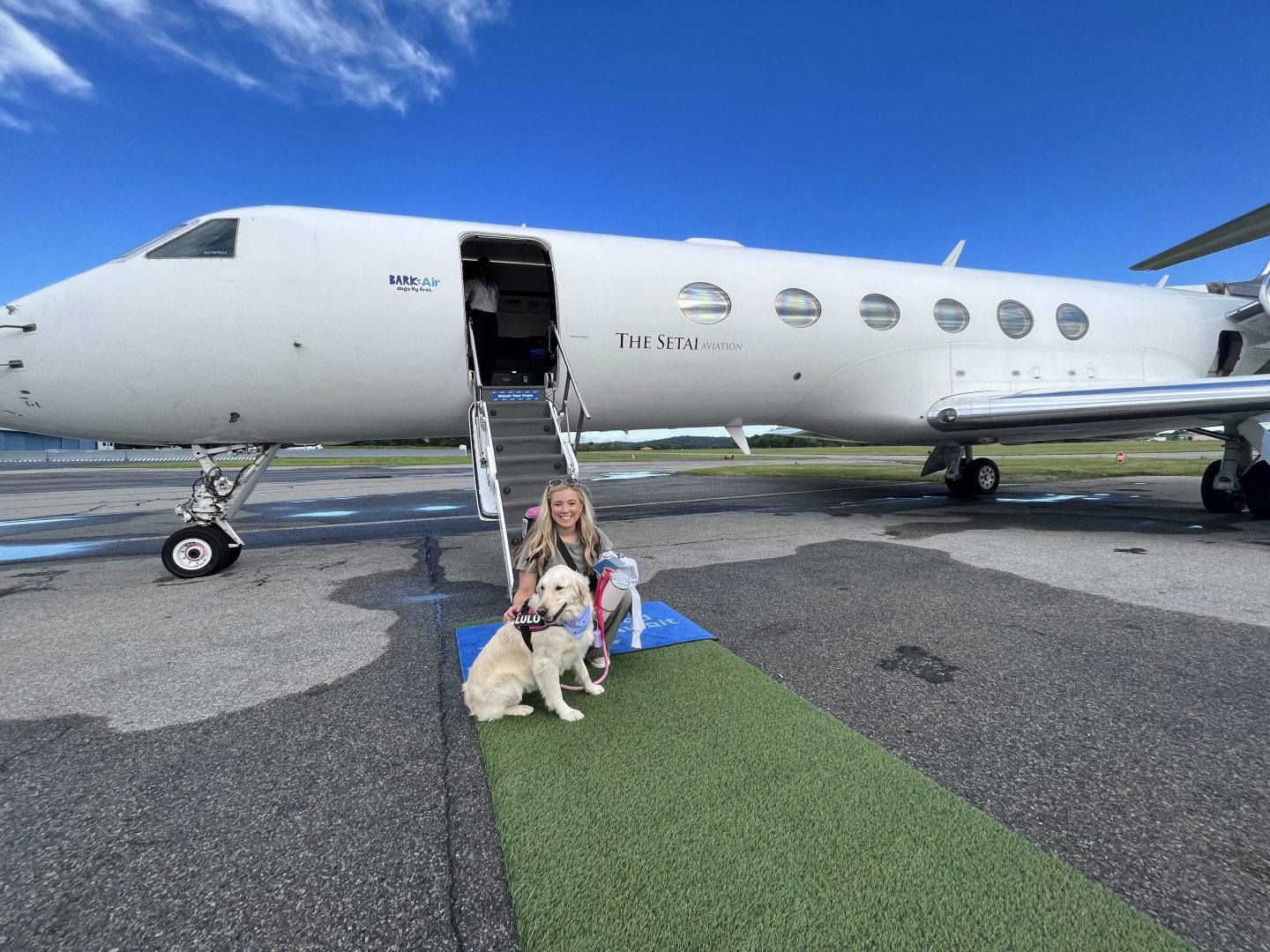 Dog and owner standing outside private jet