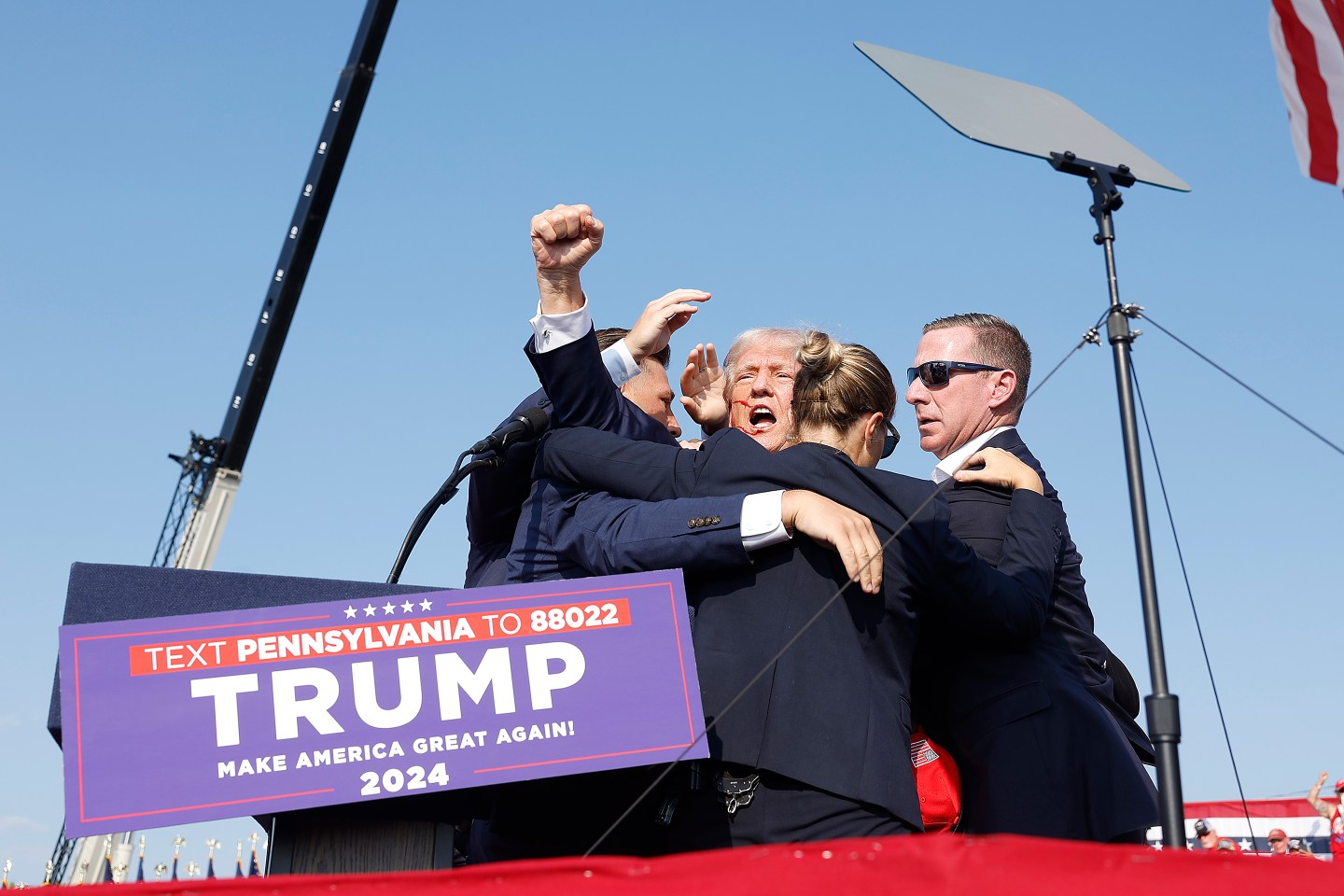 Republican presidential candidate former President Donald Trump is rushed offstage during a rally on July 13, 2024 in Butler, Pennsylvania. Shares of gun and ammo makers rise after assassination attempt.