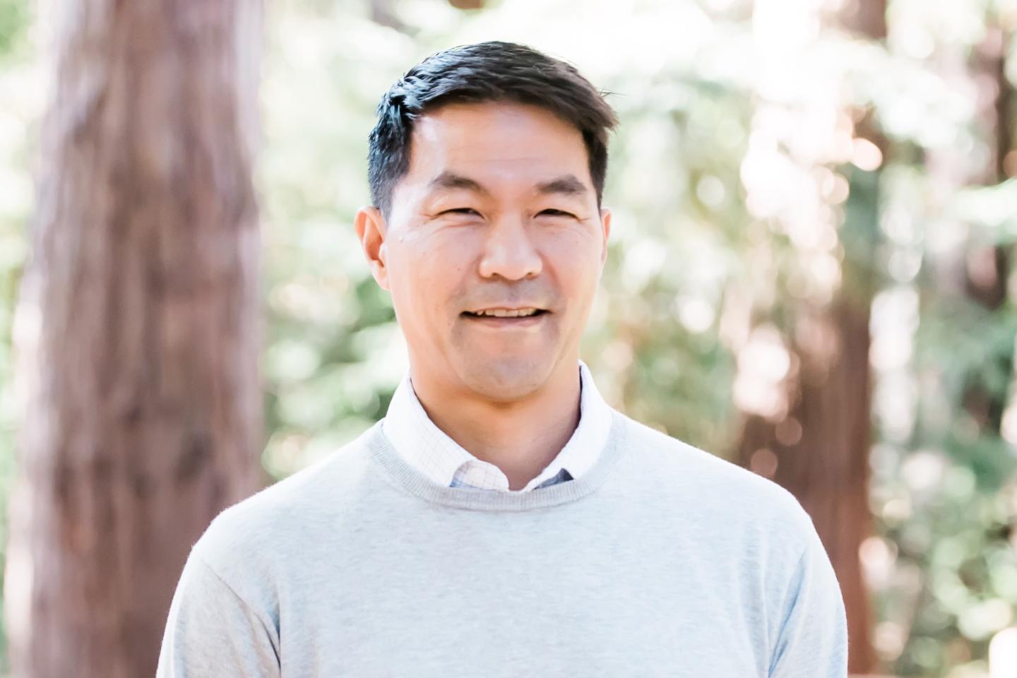 David Yuan, founder and partner at Tidemark, smiling for a portrait in the outdoors