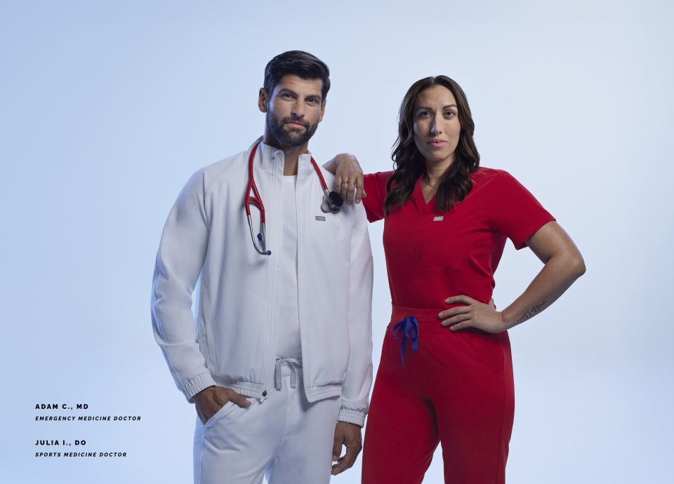 Dr. Adam C. (left), an emergency medicine physician, and Dr. Julia I., a sports medicine physician, wear Team USA Medical Team gear designed by Figs. More than 250 health care professionals will wear the uniforms at the 2024 Summer Olympics and Paralympics in Paris.