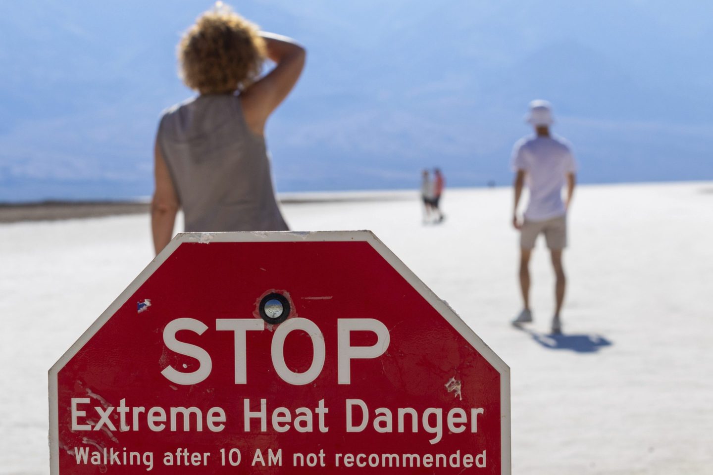 A person wipes sweat from their brow at Badwater Basin in Death Valley National Park, Calif., July 7, 2024.