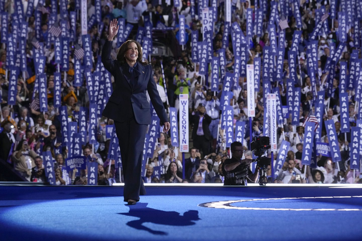 Kamala Harris waves on stage