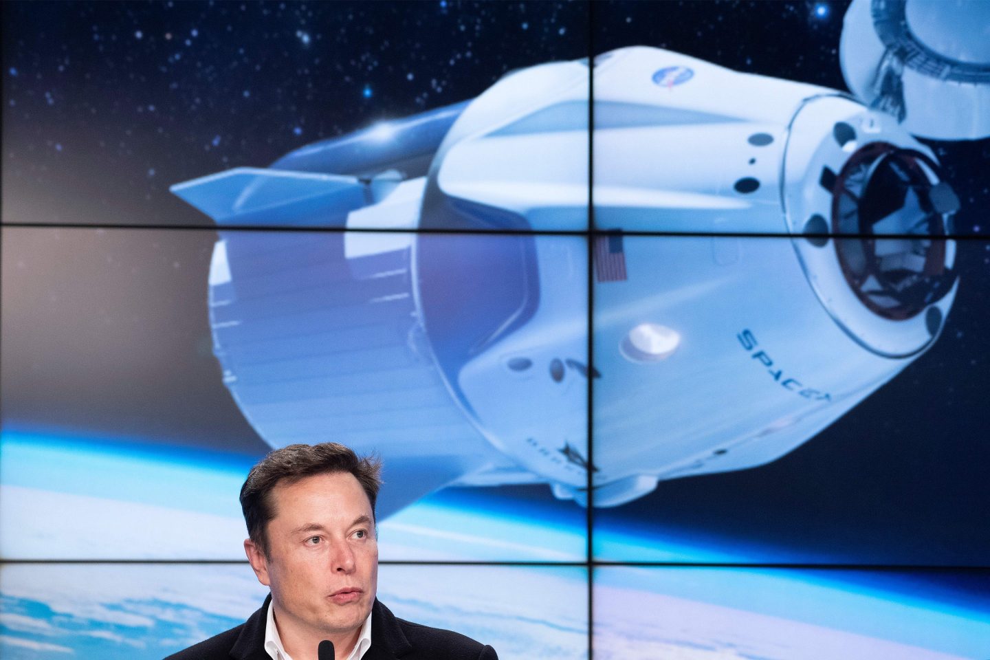 Elon Musk speaks into microphone