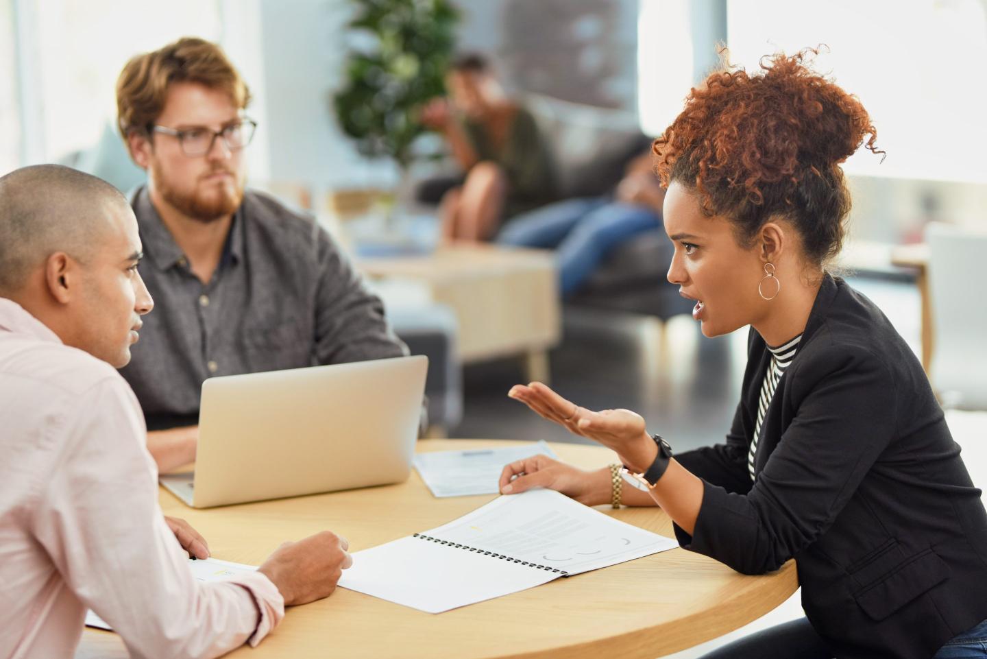 Employees in a tense workplace conversation.