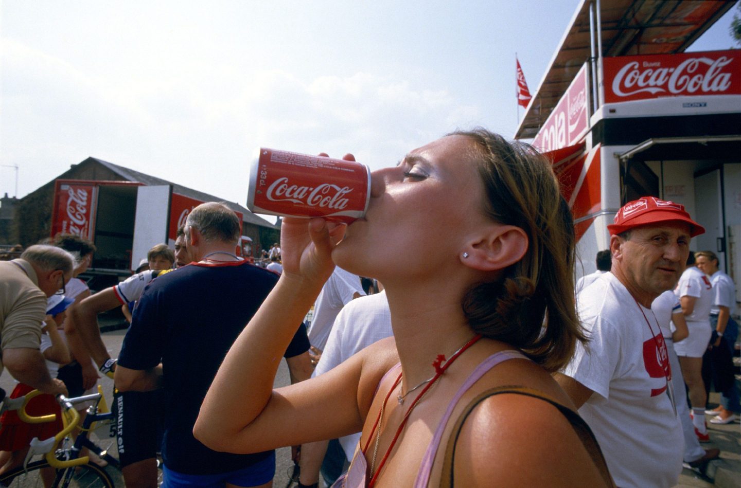 Young woman drinking a can of Coca-Cola
