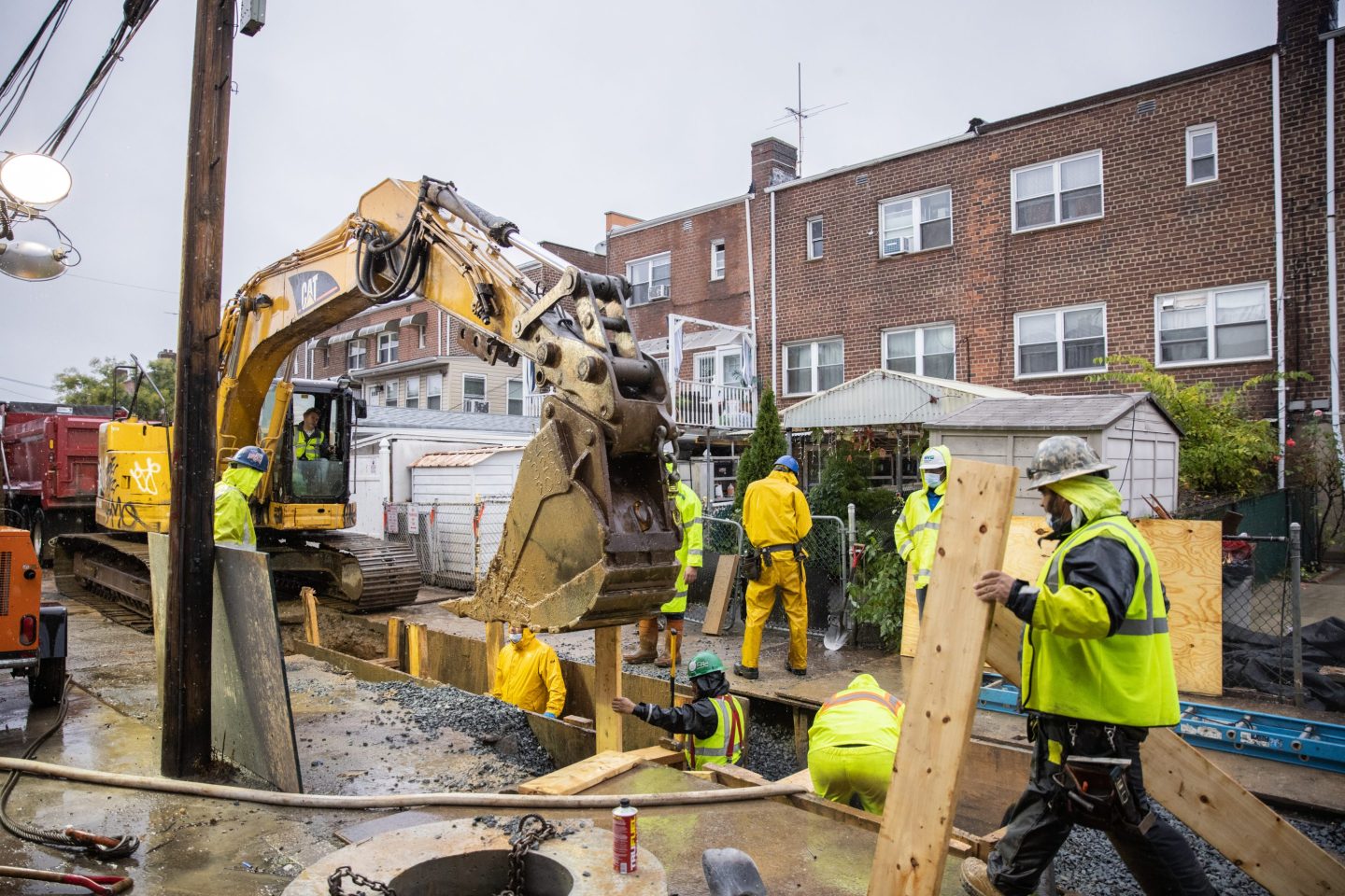 Workers on a construction site repair damage from Hurricane Ida in the East Elmhurst neighborhood of Queens, New York, on, Oct. 26, 2021. Eleven people drowned in basement apartments in 2021 amid rain from the remnants of Hurricane Ida.