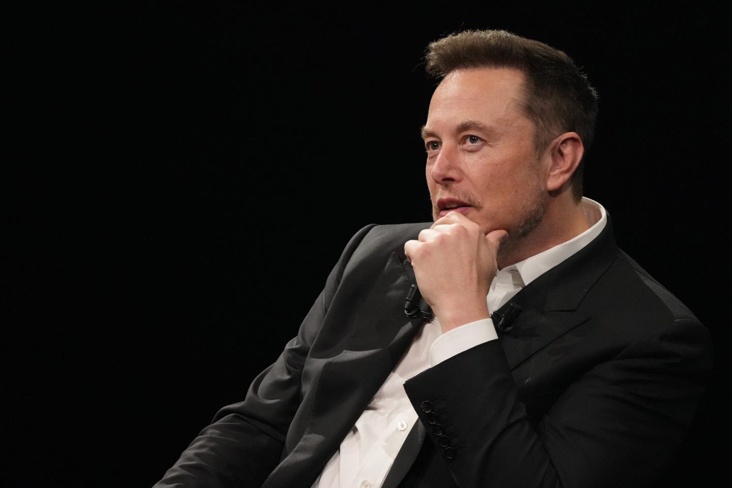 Elon Musk puts hand on chin