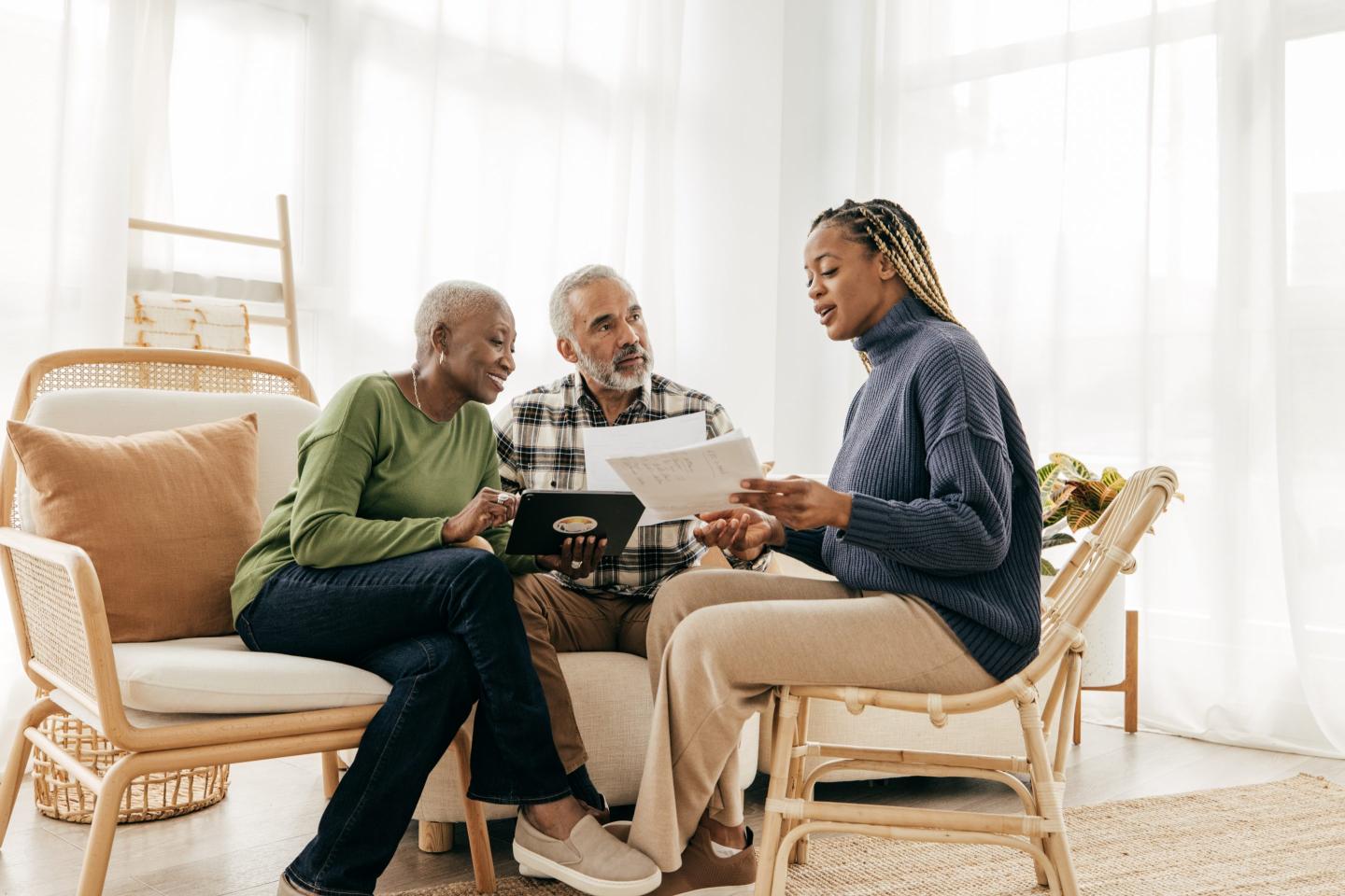A health care worker advises a senior couple