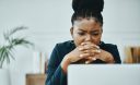 Woman frowns at computer screen