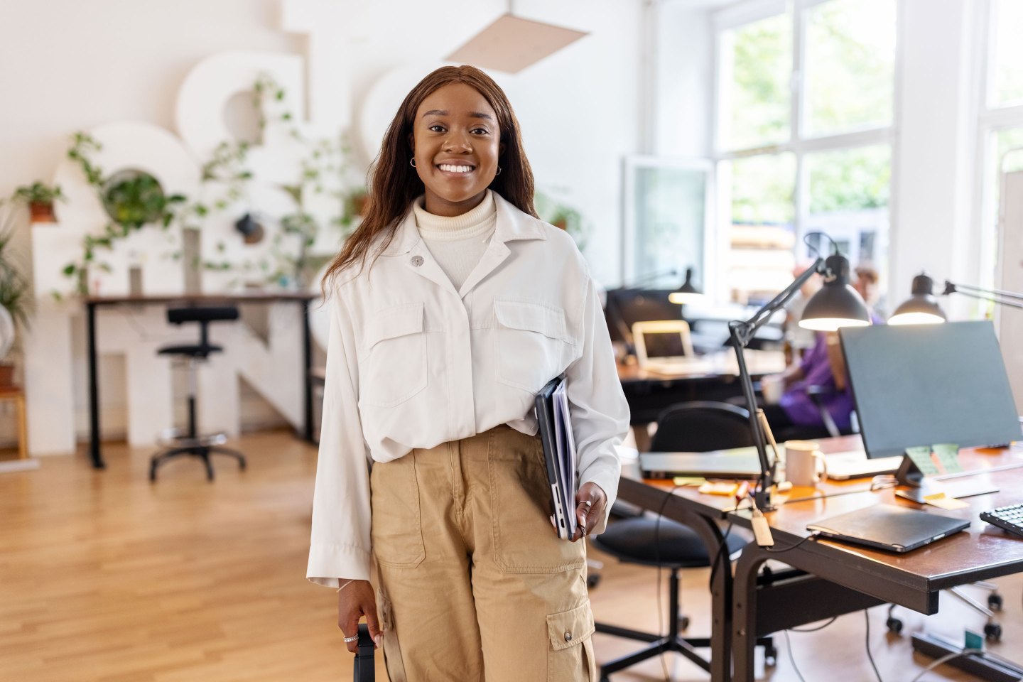 Young African American businesswoman standing at office.