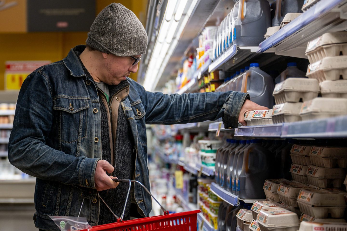 Man looking at eggs in grocery store