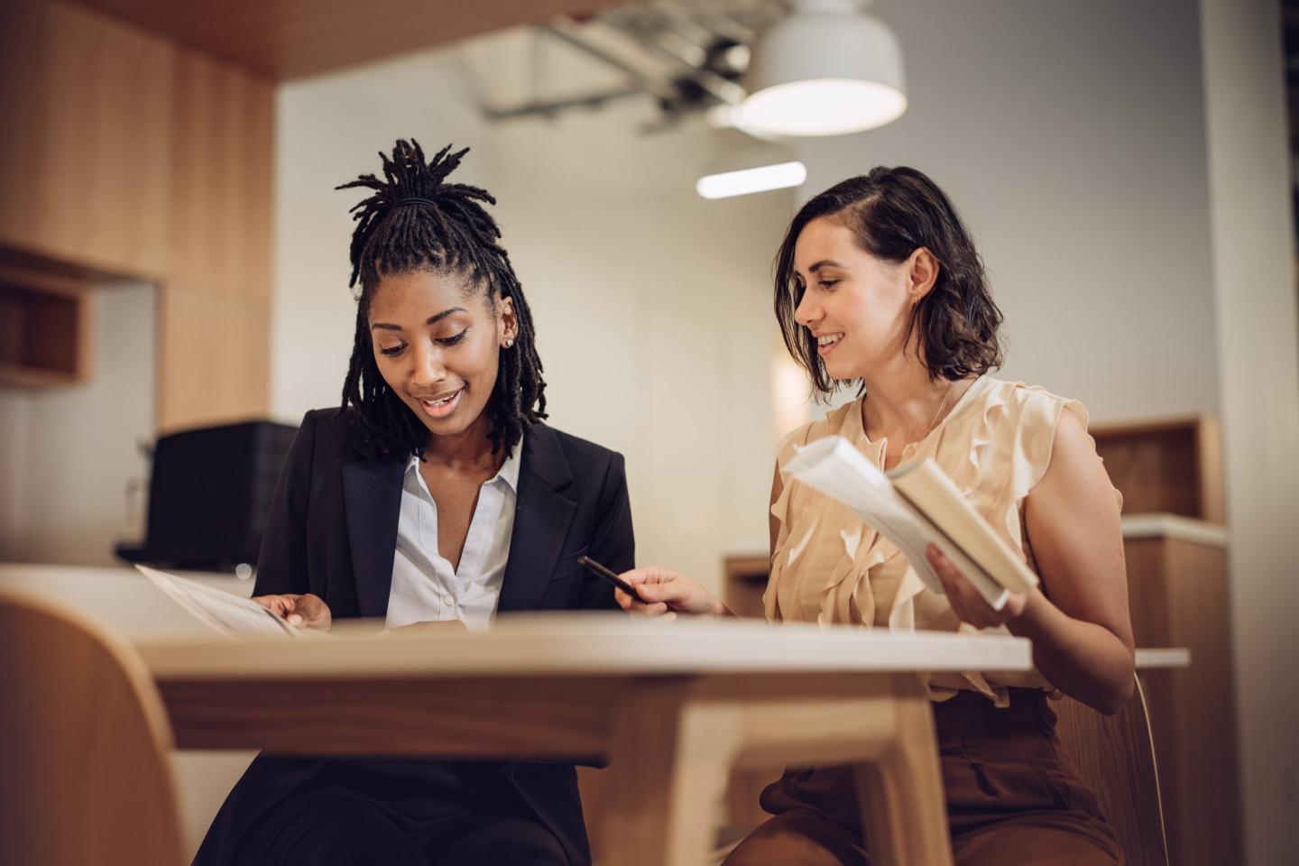 Two employees strategize together.