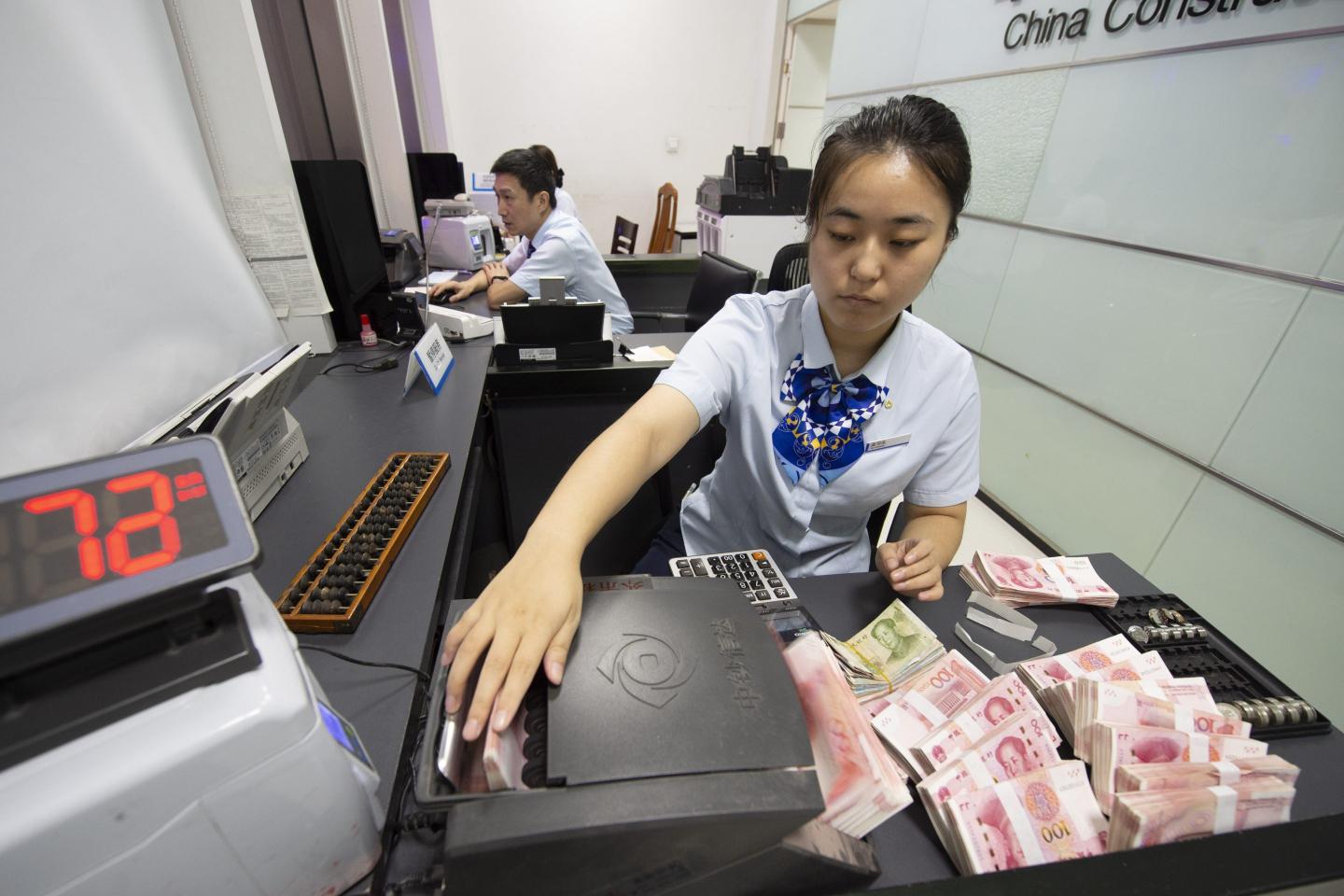 woman counting yuan notes