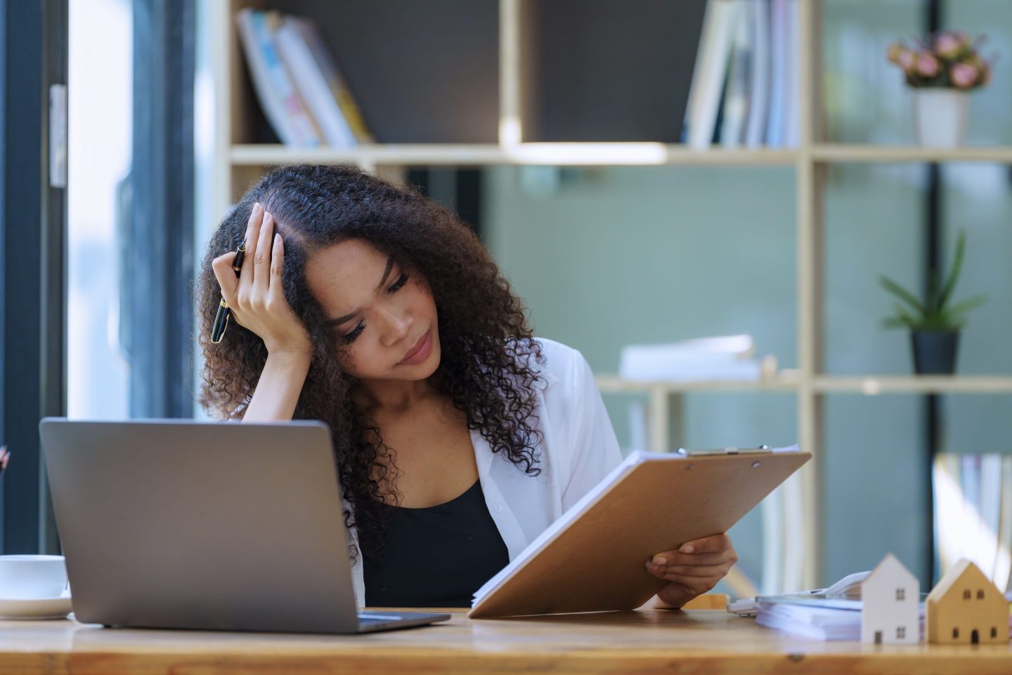 Woman looking at her laptop with a concerned look