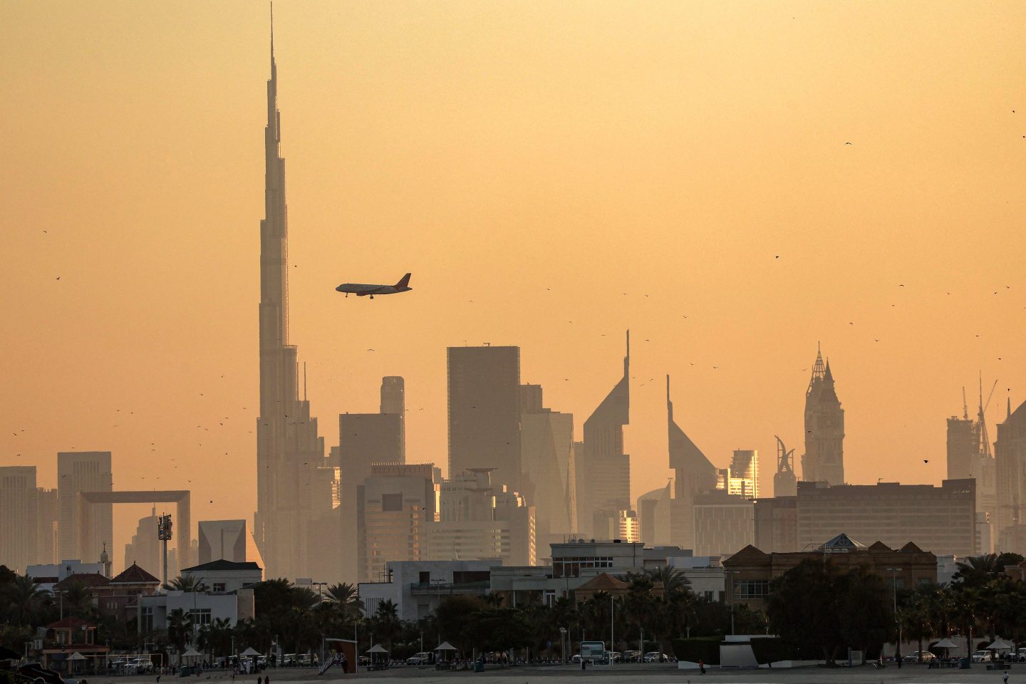 Air India flies near the landmark Burj Khalifa skyscraper,