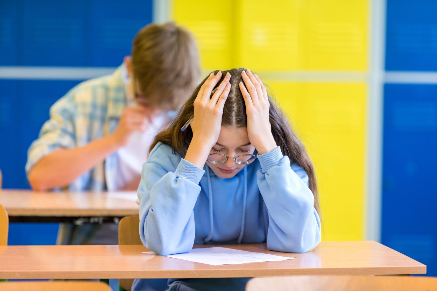 a female student looking stressed in a classroom