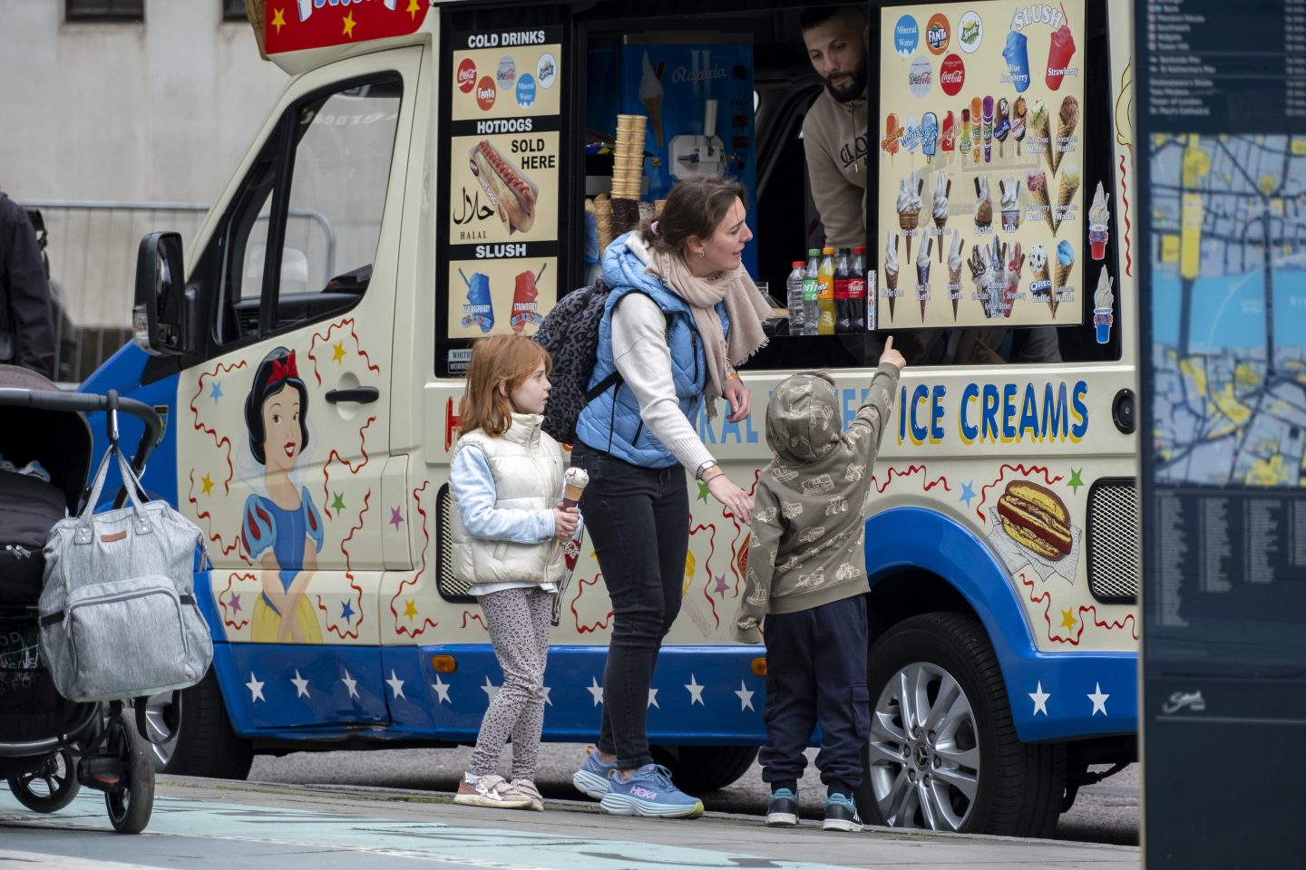 A family orders ice cream from an ice cream truck.