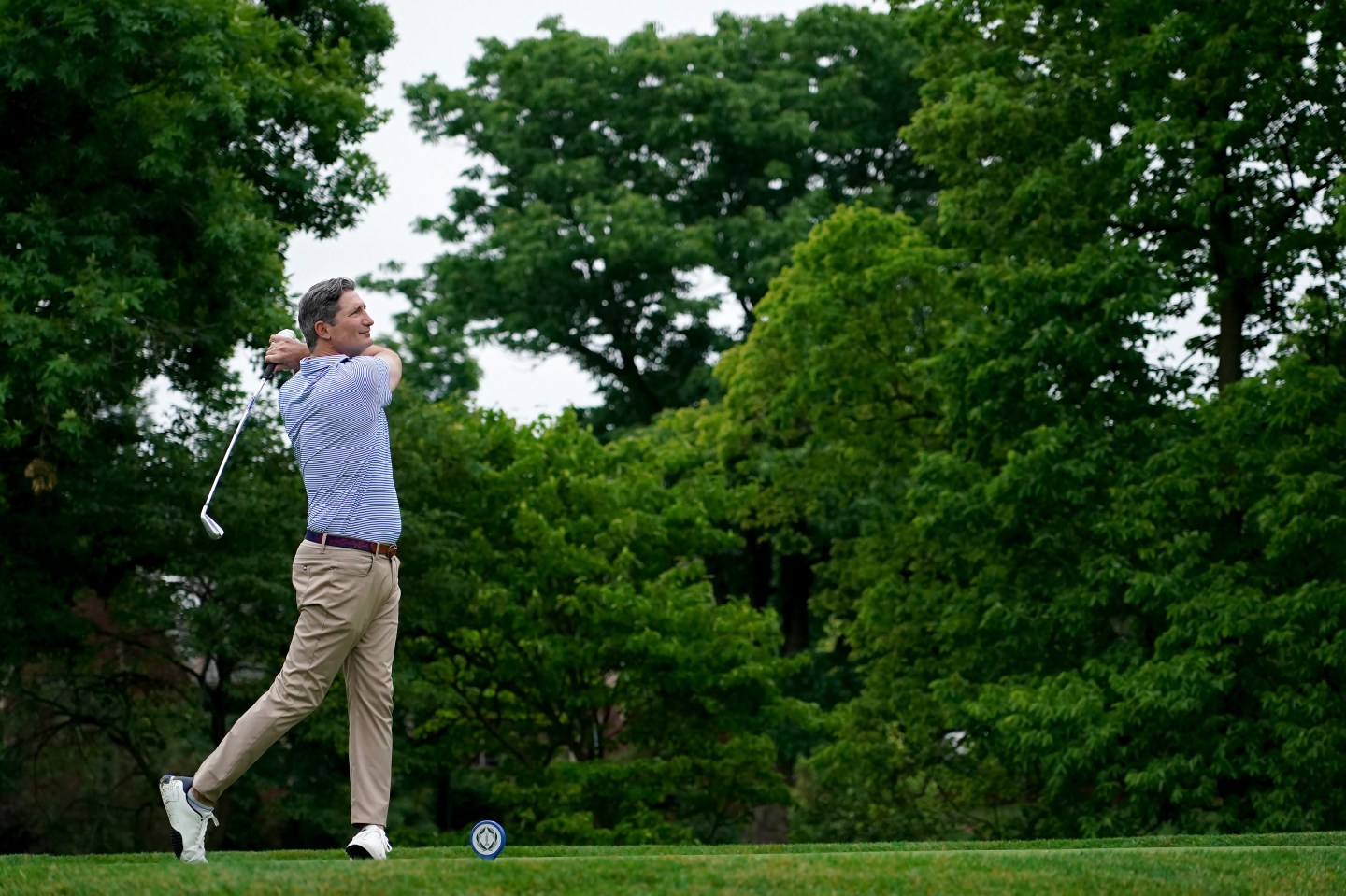 Chipotle CEO Brian Niccol plays his shot a golf tournament in Ohio on June 5.