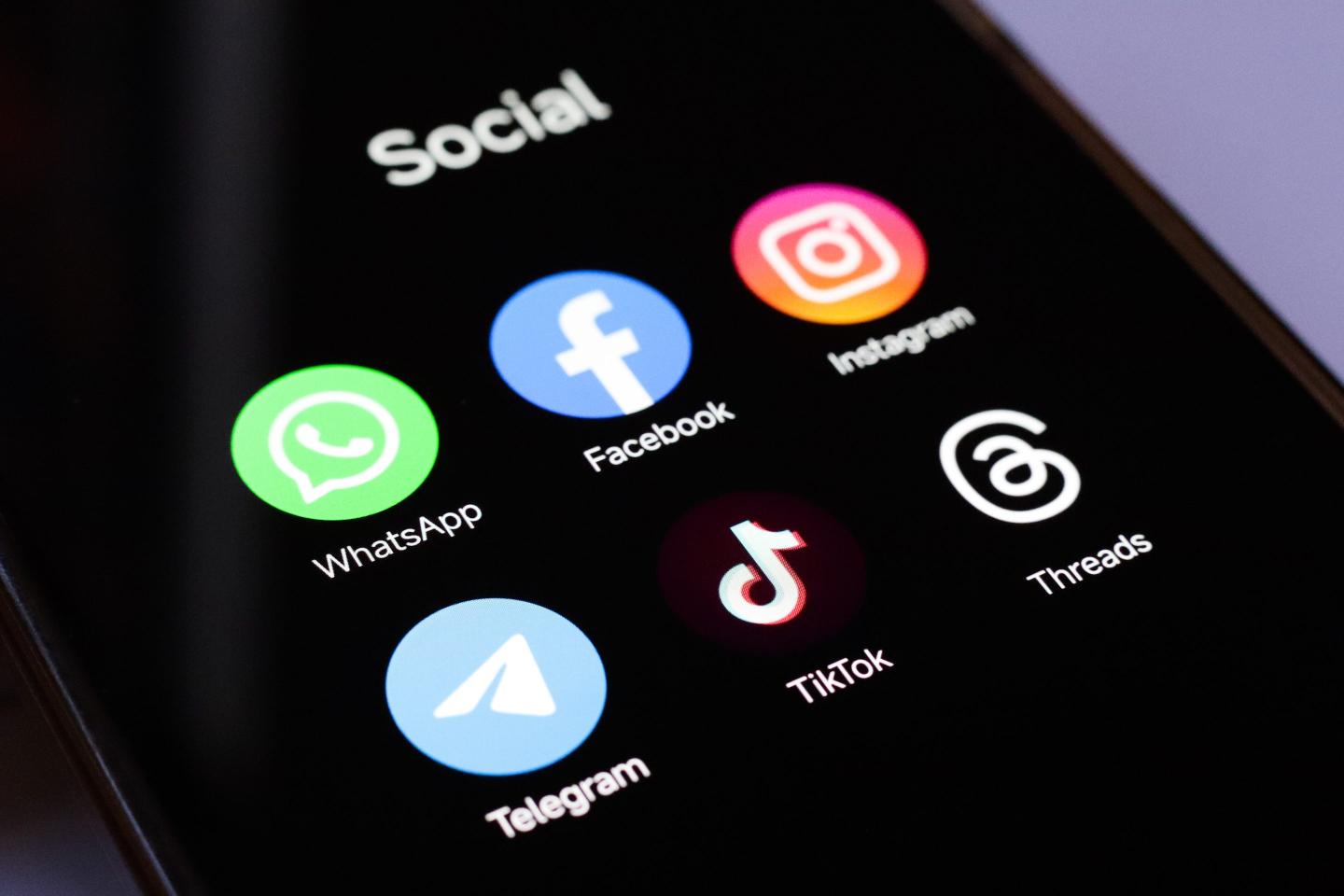 In this photo illustration, WhatsApp, Facebook, Instagram, Telegram, TikTok and Threads apps displayed on a smartphone screen.