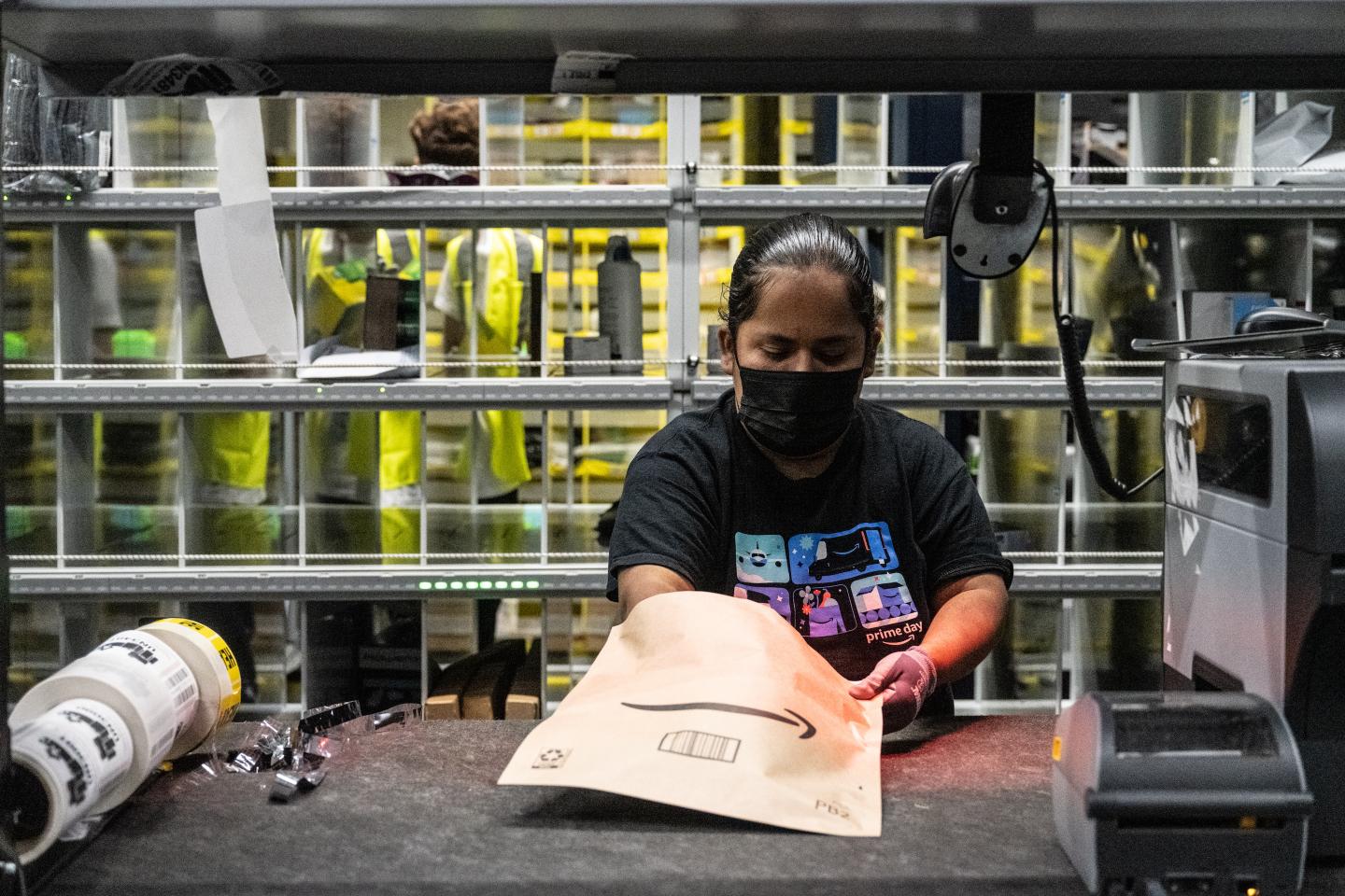 A worker prepares packages at an Amazon fulfillment center on Prime Day.
