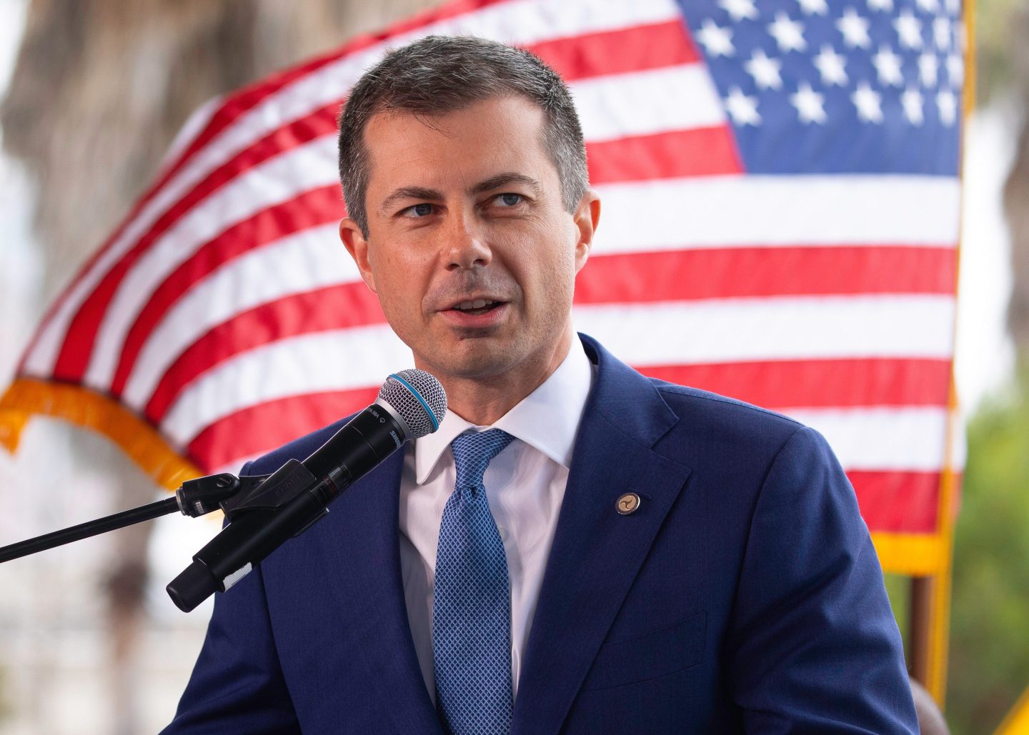 Pete Buttigieg in front of US flag