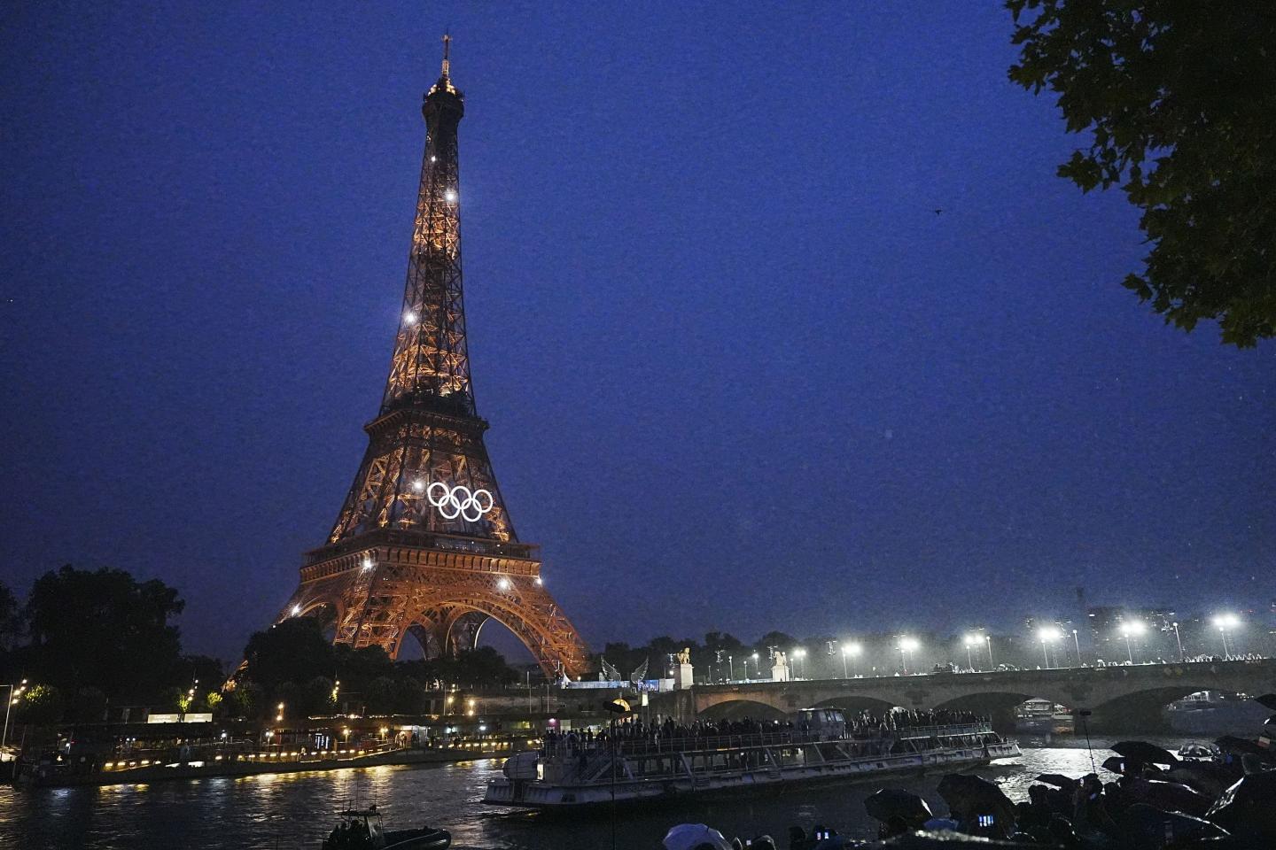 Lights illuminate the Eiffel Tower during the opening ceremony of the Paris 2024 Olympic Games 