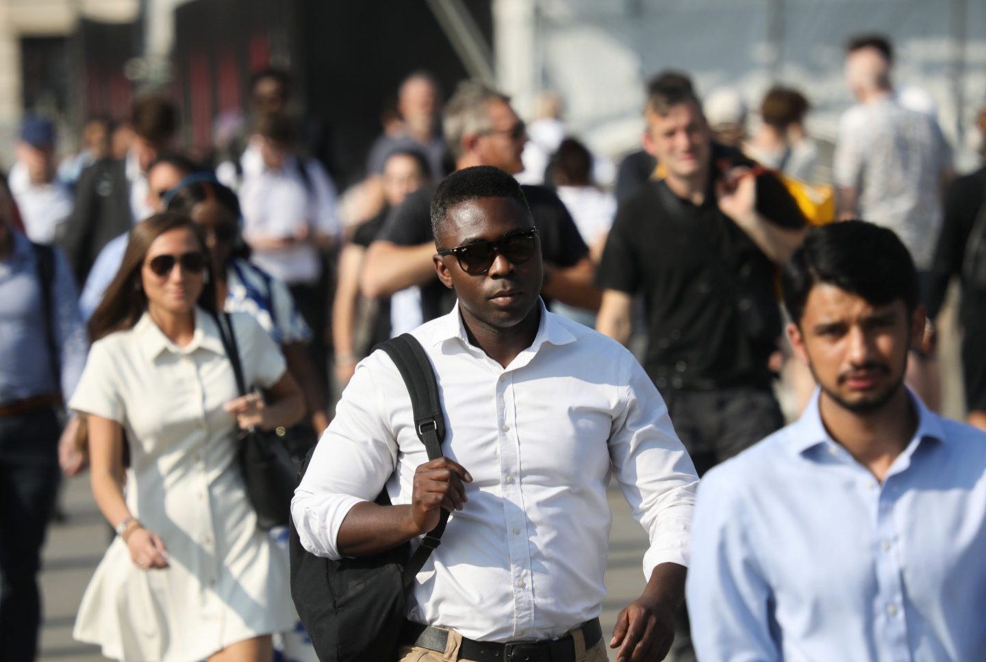 People walk across London Bridge from the City of London in the evening sun on the hottest day of the year so far on the 30th of July 2024, London, United Kingdom. Many are office workers heading towards London Bridge Station and home after a long day at work in the City of London. The Met Office announced the same day that it recorded 32°C at Kew Gardens and Heathrow in London, making it the country's so far warmest day of the year. (photo by Kristian Buus/In Pictures via Getty Images)