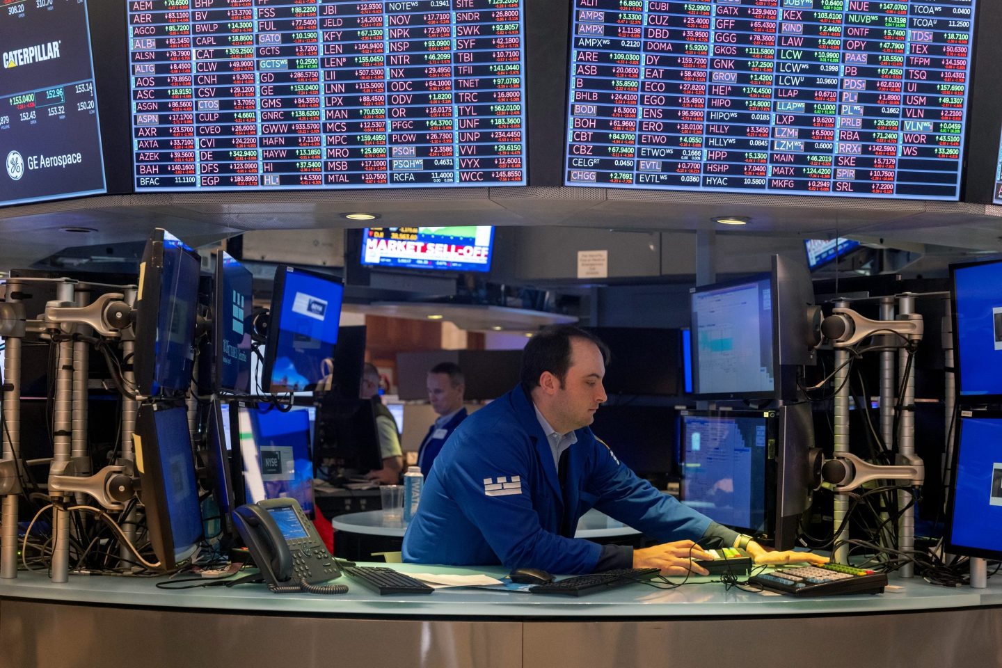 Traders work on the floor of the New York Stock Exchange on Aug. 5, 2024. The Dow fell over 1,000 points in morning trading as global stocks plunged following fears of a recession in the American and Japanese economies.
