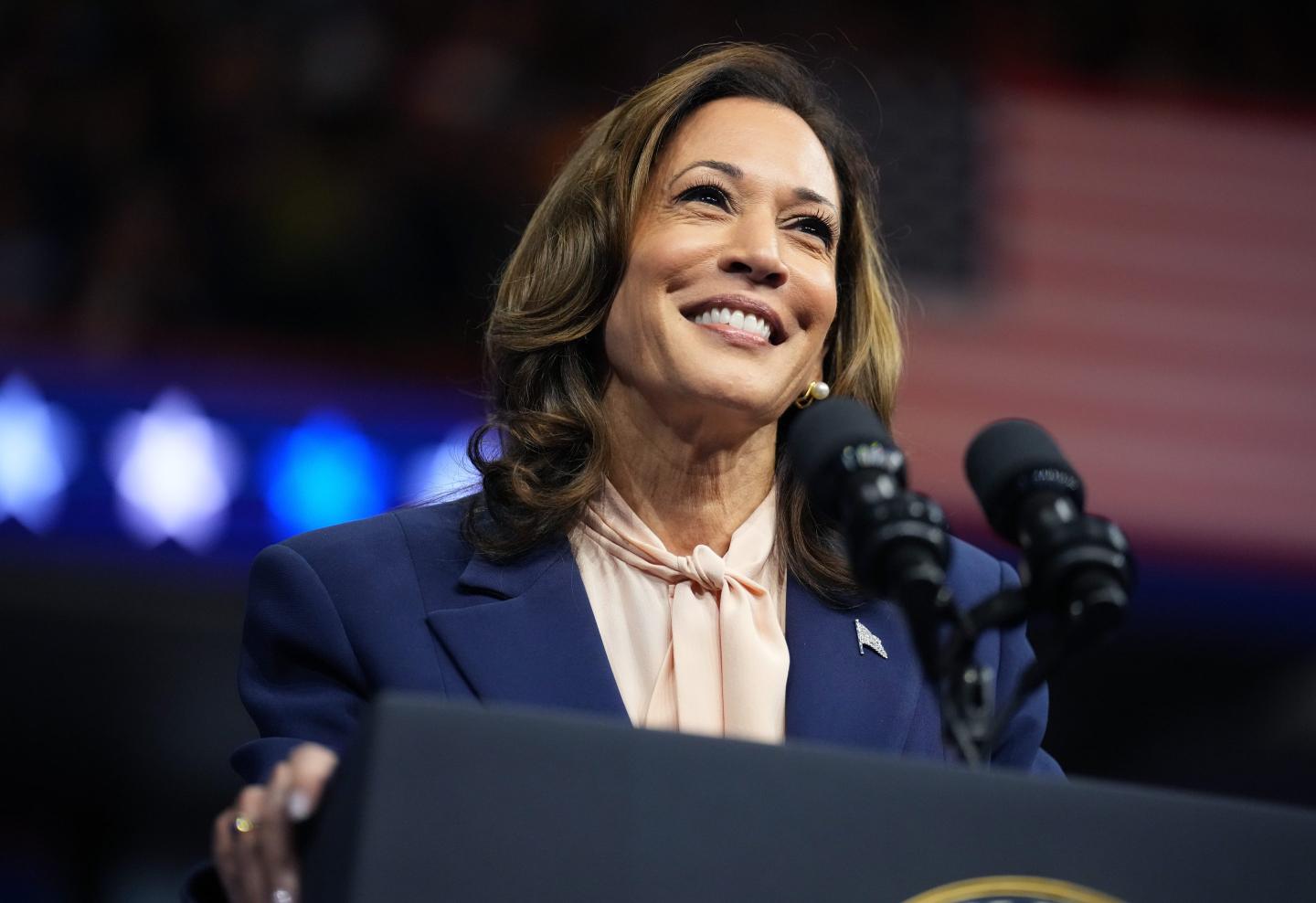 Kamala Harris smiling at a podium